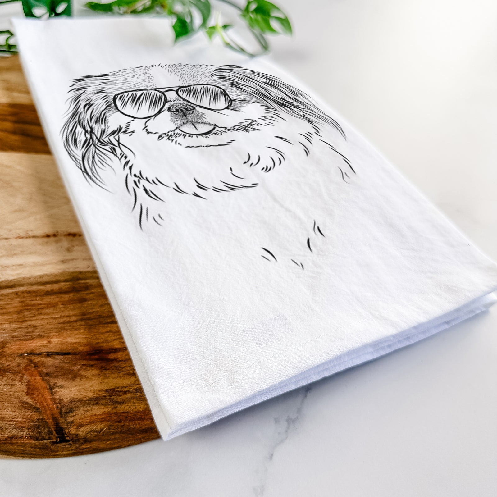 Hand-drawn sketch of Abra Bean the Pekingese wearing aviator sunglasses on a tea towel