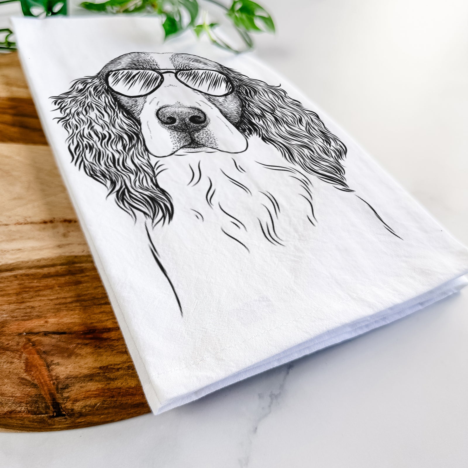 Hand-drawn sketch of Annie the English Springer Spaniel wearing aviator sunglasses on a tea towel
