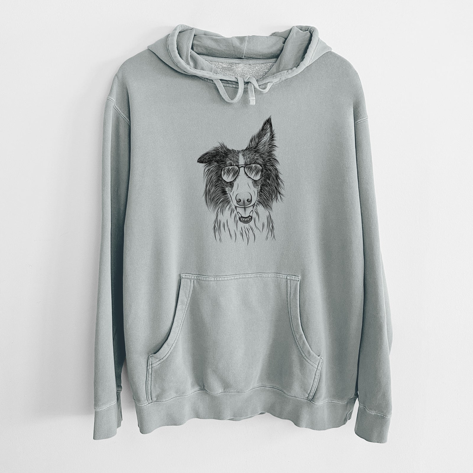 Hand-drawn sketch of Archie the Silken Windhound wearing aviator sunglasses on a Sage Unisex pigment dyed hoodie