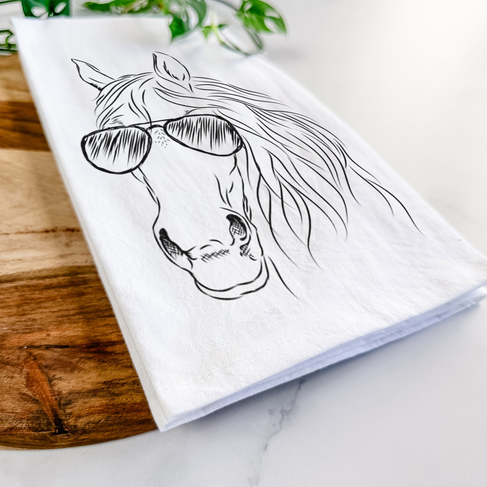 Hand-drawn sketch of Aria the Horse wearing aviator sunglasses on a tea towel