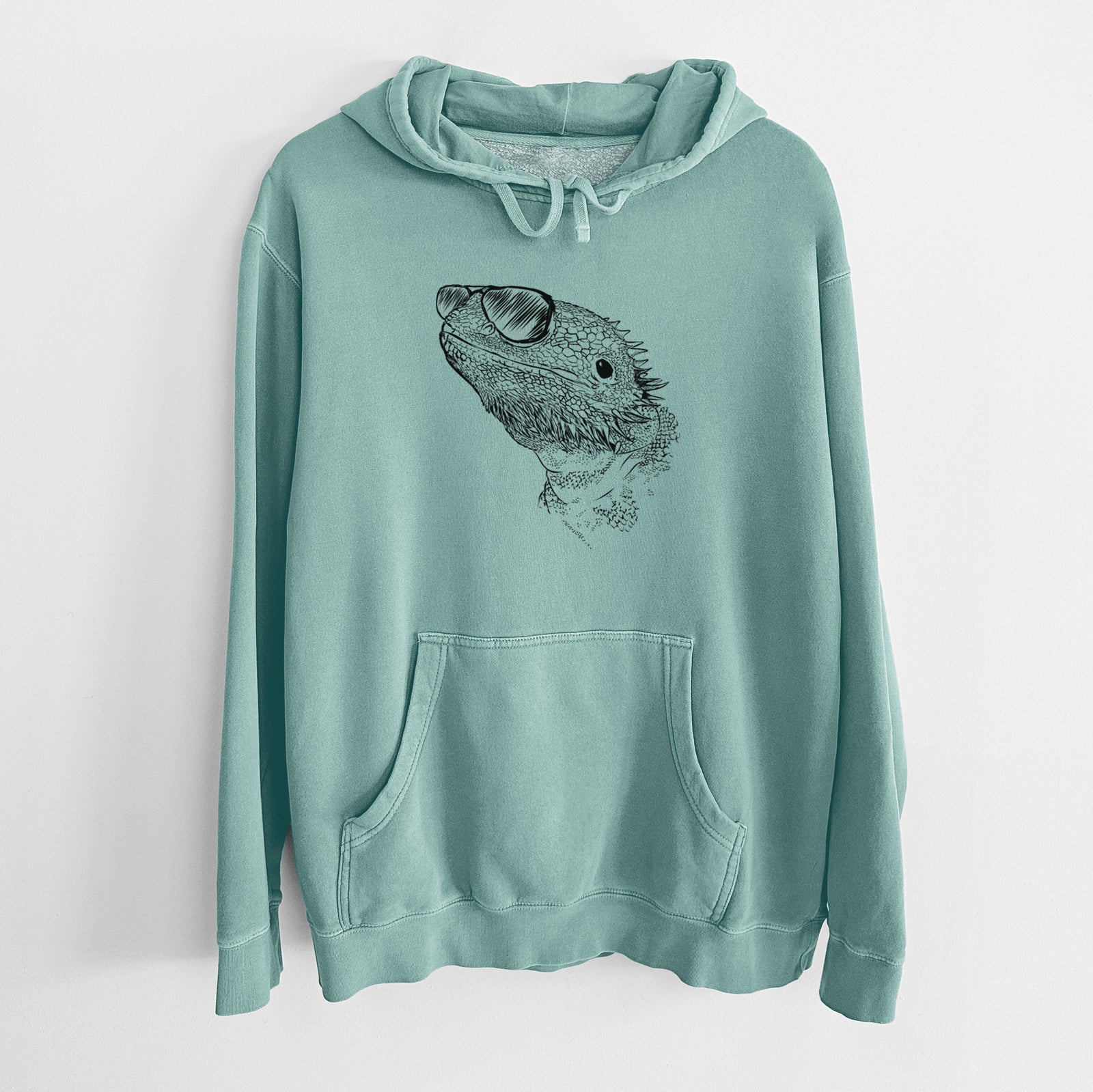 Hand-drawn sketch of Ash the Bearded Dragon wearing aviator sunglasses on a Mint Unisex pigment dyed hoodie
