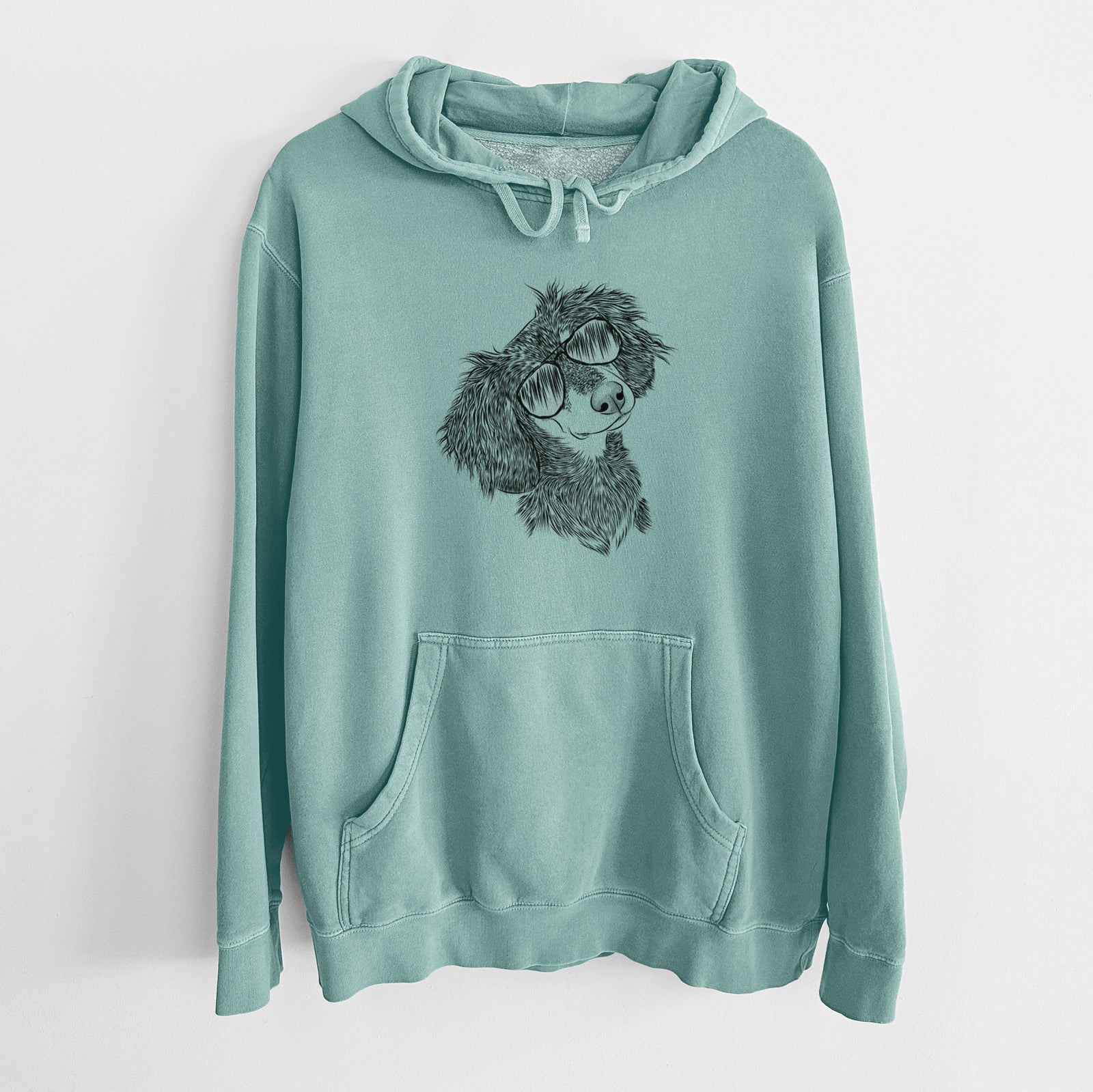 Hand-drawn sketch of Bailey the Long Haired Dachshund wearing aviator sunglasses on a Mint Unisex pigment dyed hoodie