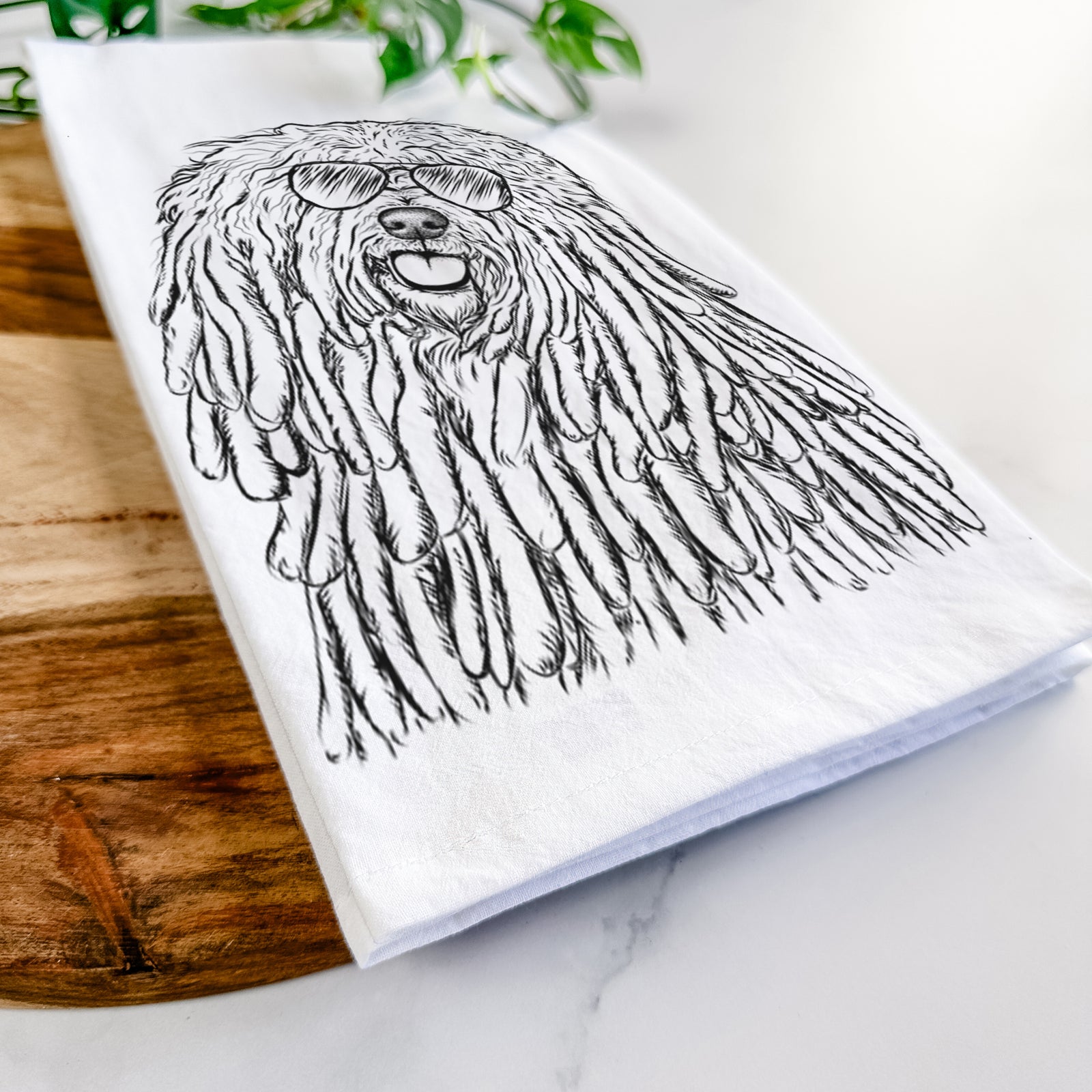 Hand-drawn sketch of Barry the Komondor wearing aviator sunglasses on a tea towel