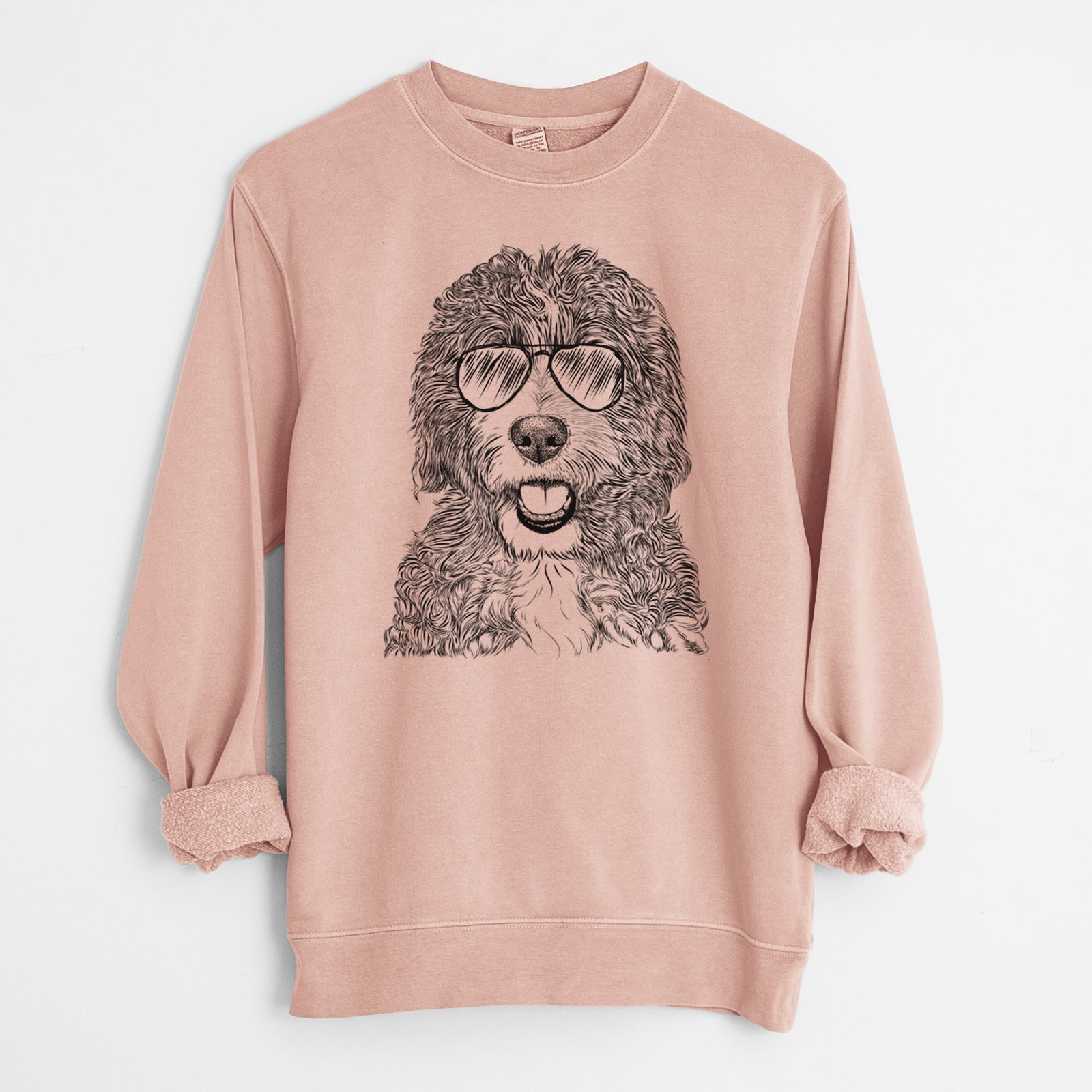 Hand-drawn sketch of Bash the Bernedoodle wearing aviator sunglasses on a Dusty Pink Unisex pigment dyed crew sweatshirt
