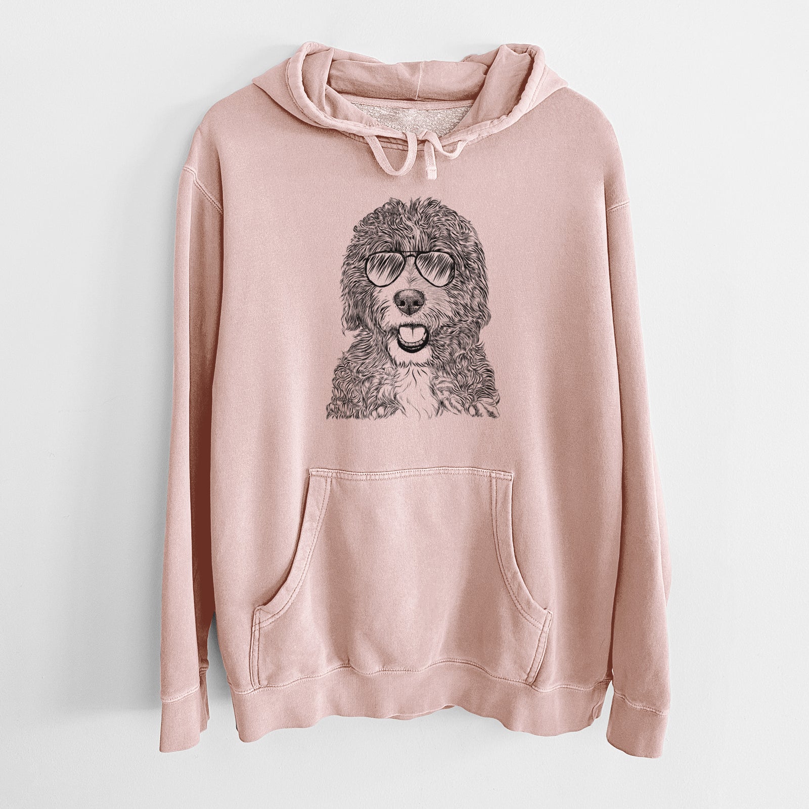 Hand-drawn sketch of Bash the Bernedoodle wearing aviator sunglasses on a Dusty Pink Unisex pigment dyed hoodie