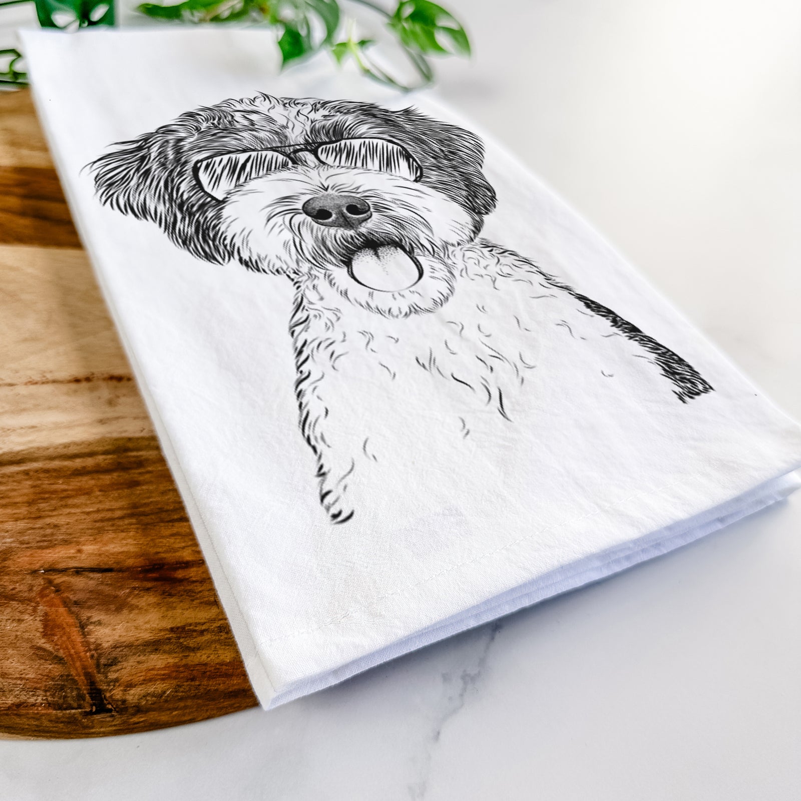 Hand-drawn sketch of Bella the Cockapoo wearing aviator sunglasses on a tea towel