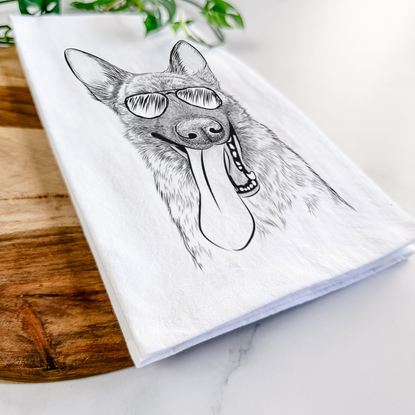 Hand-drawn sketch of Bessa the Dutch Shepherd wearing aviator sunglasses on a tea towel