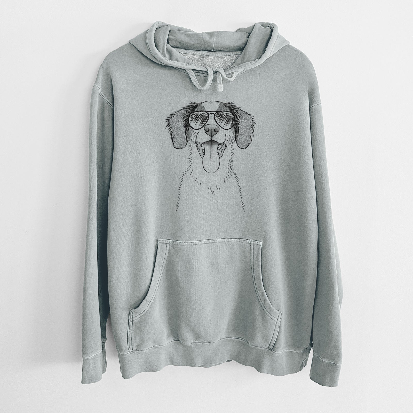 Hand-drawn sketch of Birdie the Brittany wearing aviator sunglasses on a Sage Unisex pigment dyed hoodie