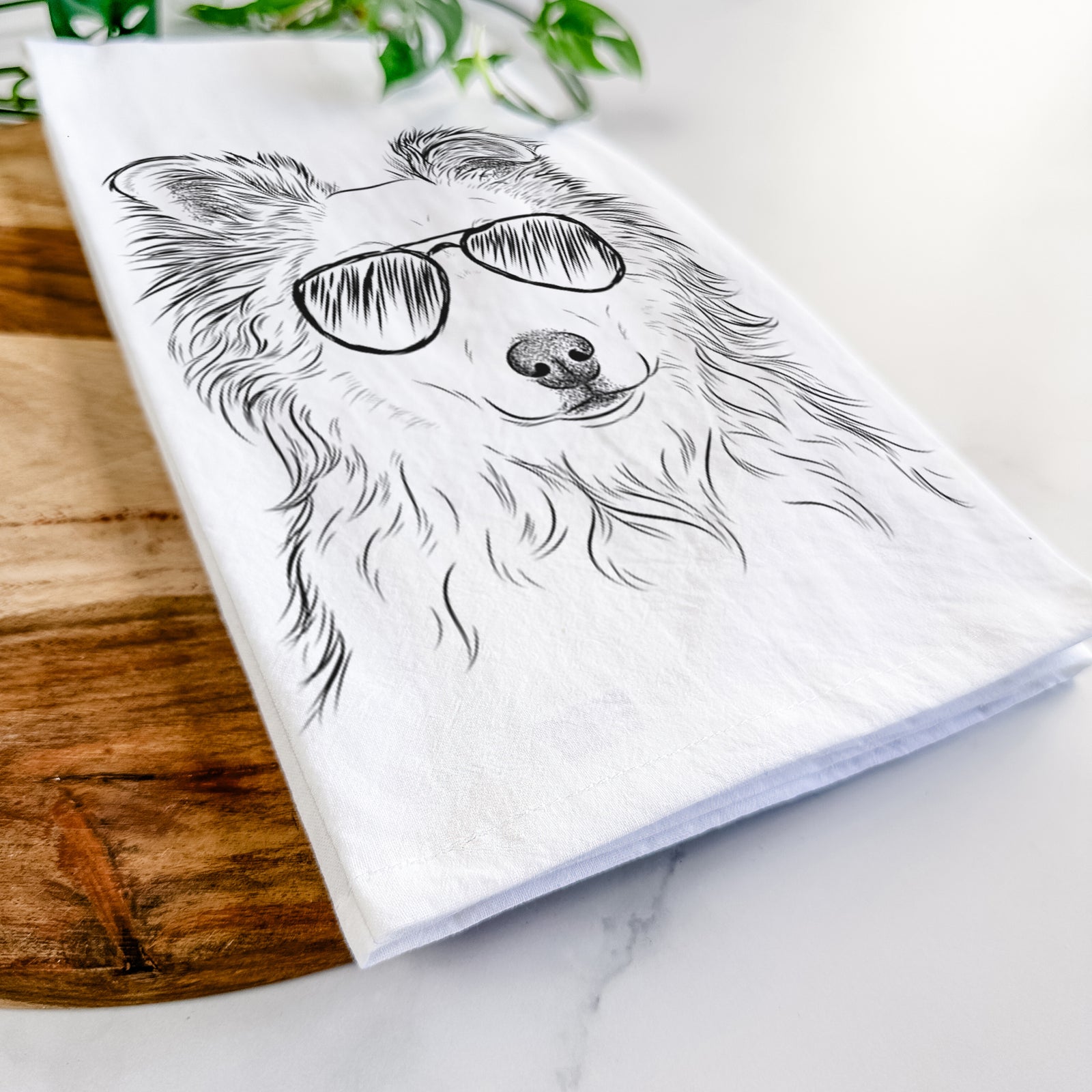 Hand-drawn sketch of Bonsai the Mixed Breed wearing aviator sunglasses on a tea towel