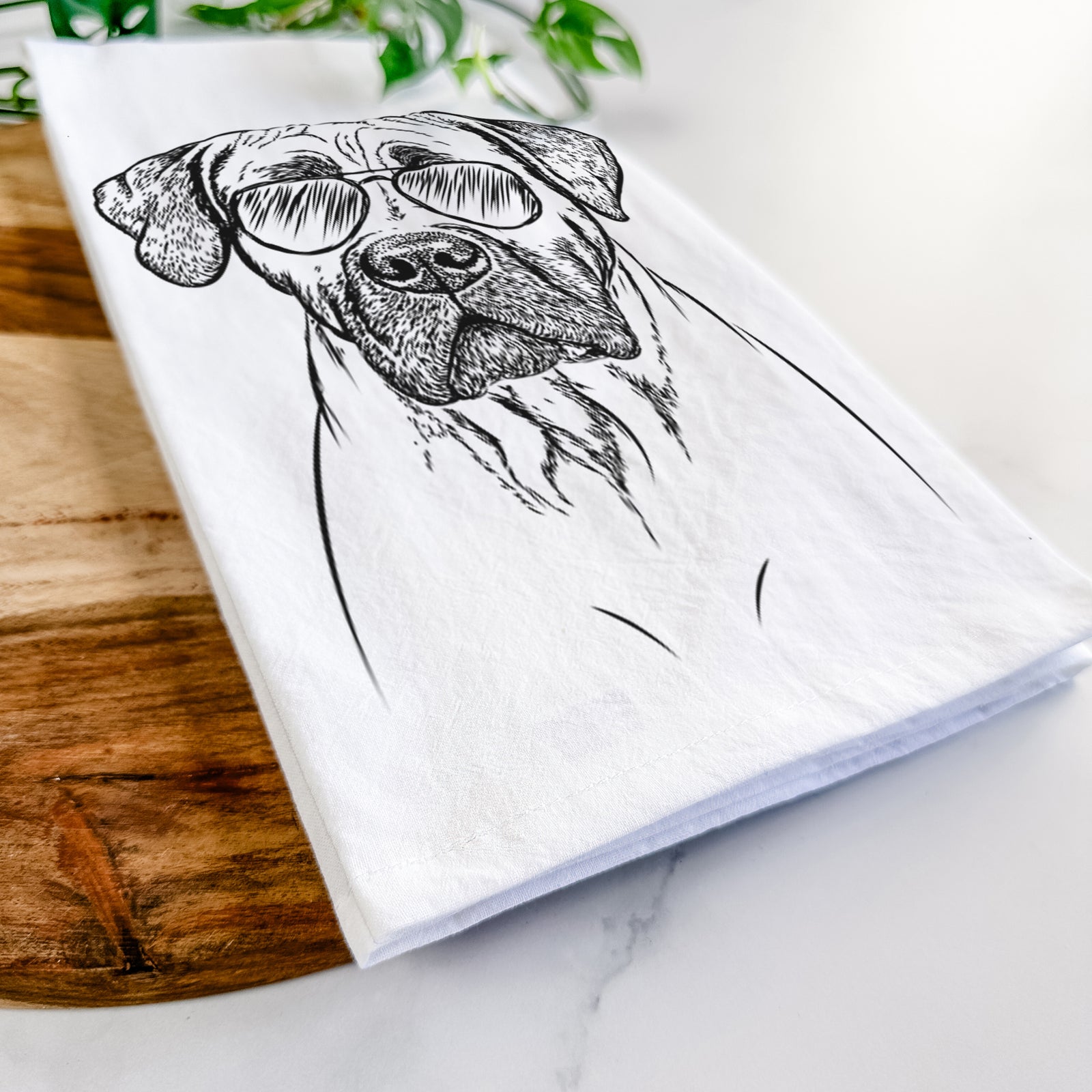 Hand-drawn sketch of Boris the Boerboel wearing aviator sunglasses on a tea towel