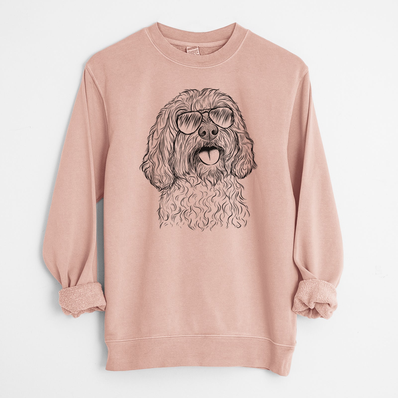Hand-drawn sketch of Cali the Cavapoo wearing aviator sunglasses on a Dusty Pink Unisex pigment dyed crew sweatshirt
