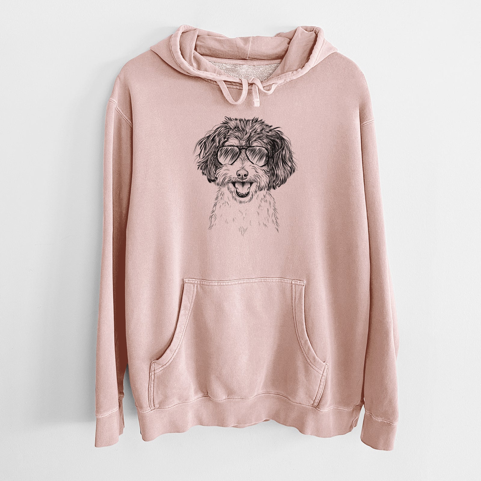 Hand-drawn sketch of Carlos the Cavapoo wearing aviator sunglasses on a Dusty Pink Unisex pigment dyed hoodie