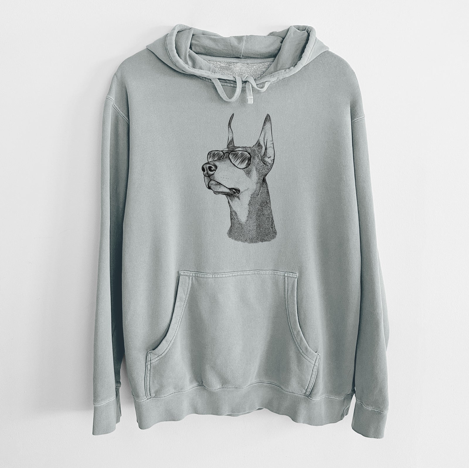 Hand-drawn sketch of Cenza the Doberman Pinscher wearing aviator sunglasses on a Sage Unisex pigment dyed hoodie