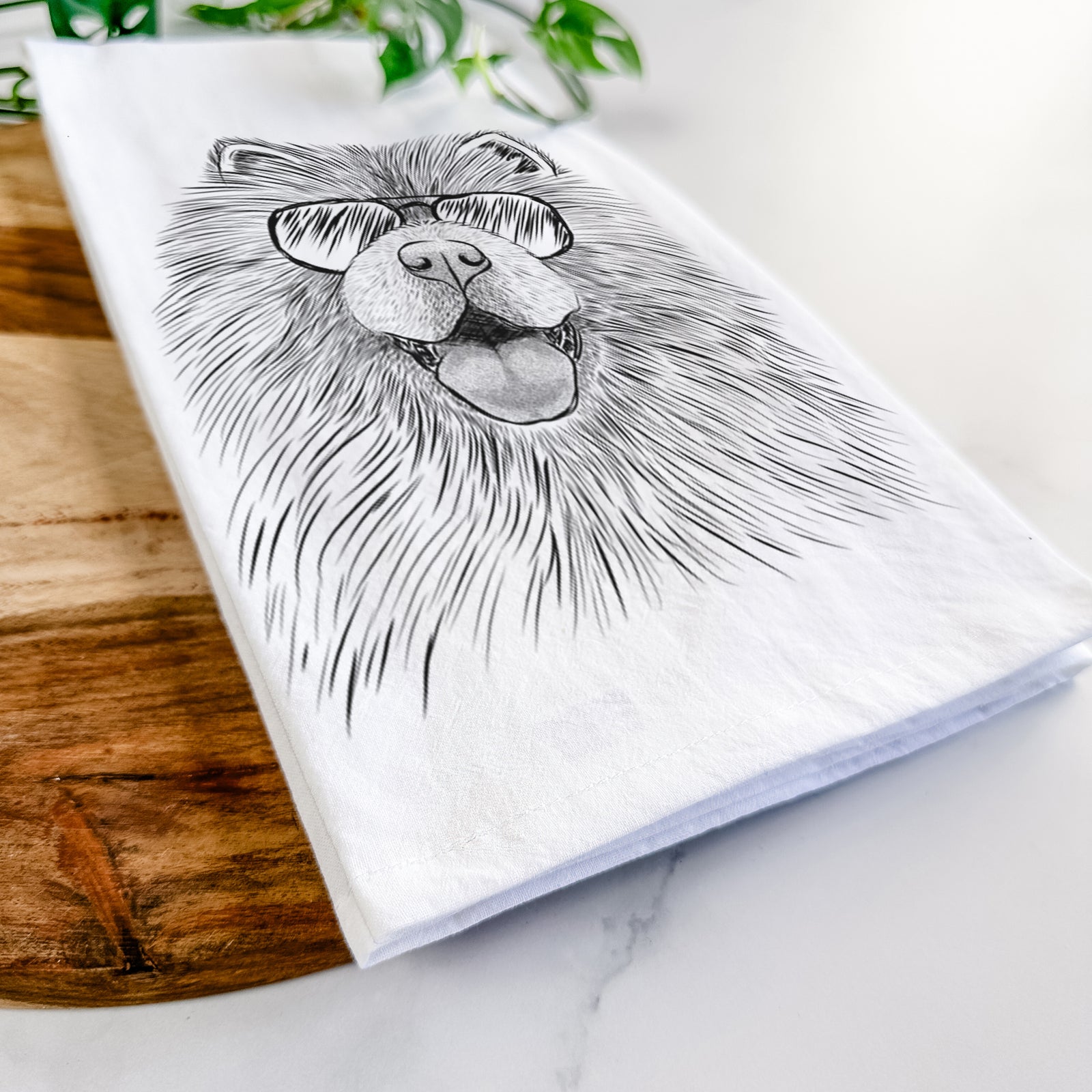 Hand-drawn sketch of Charming Charlie the Chow Chow wearing aviator sunglasses on a tea towel