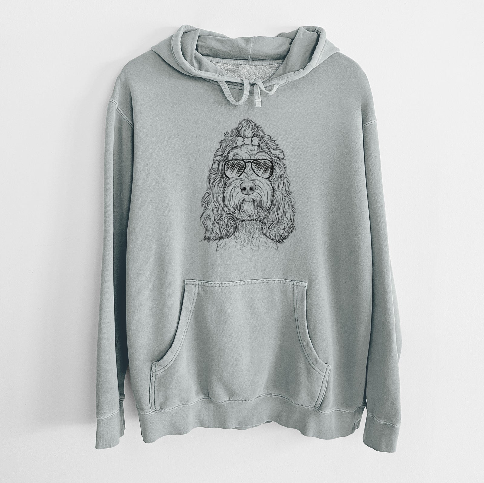 Hand-drawn sketch of Chloe the Cockapoo wearing aviator sunglasses on a Sage Unisex pigment dyed hoodie