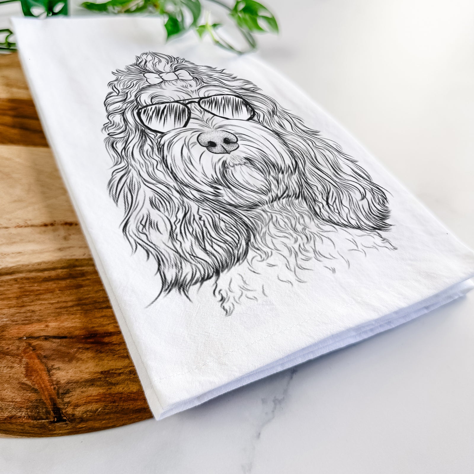 Hand-drawn sketch of Chloe the Cockapoo wearing aviator sunglasses on a tea towel
