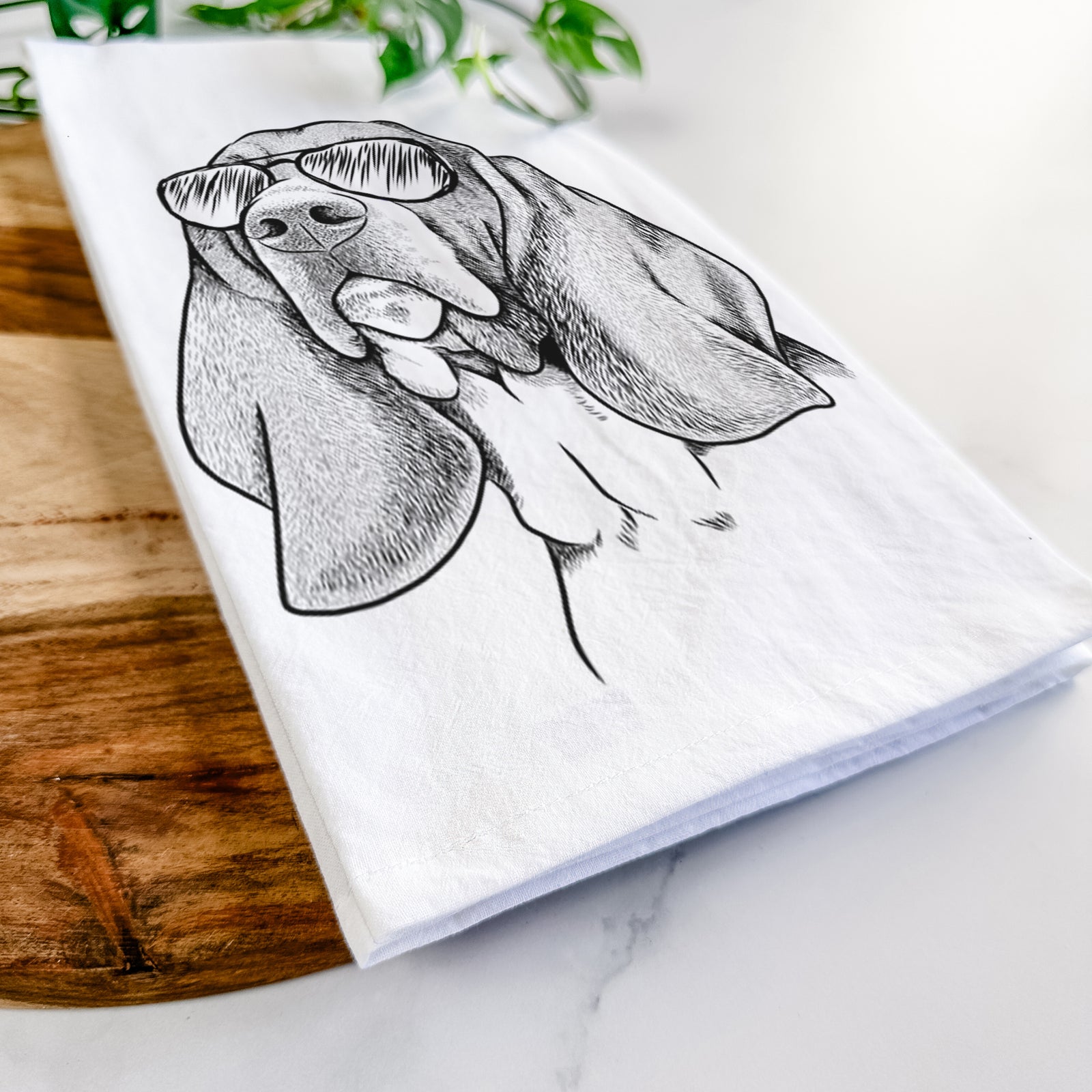 Hand-drawn sketch of Cooper the Basset Hound wearing aviator sunglasses on a tea towel