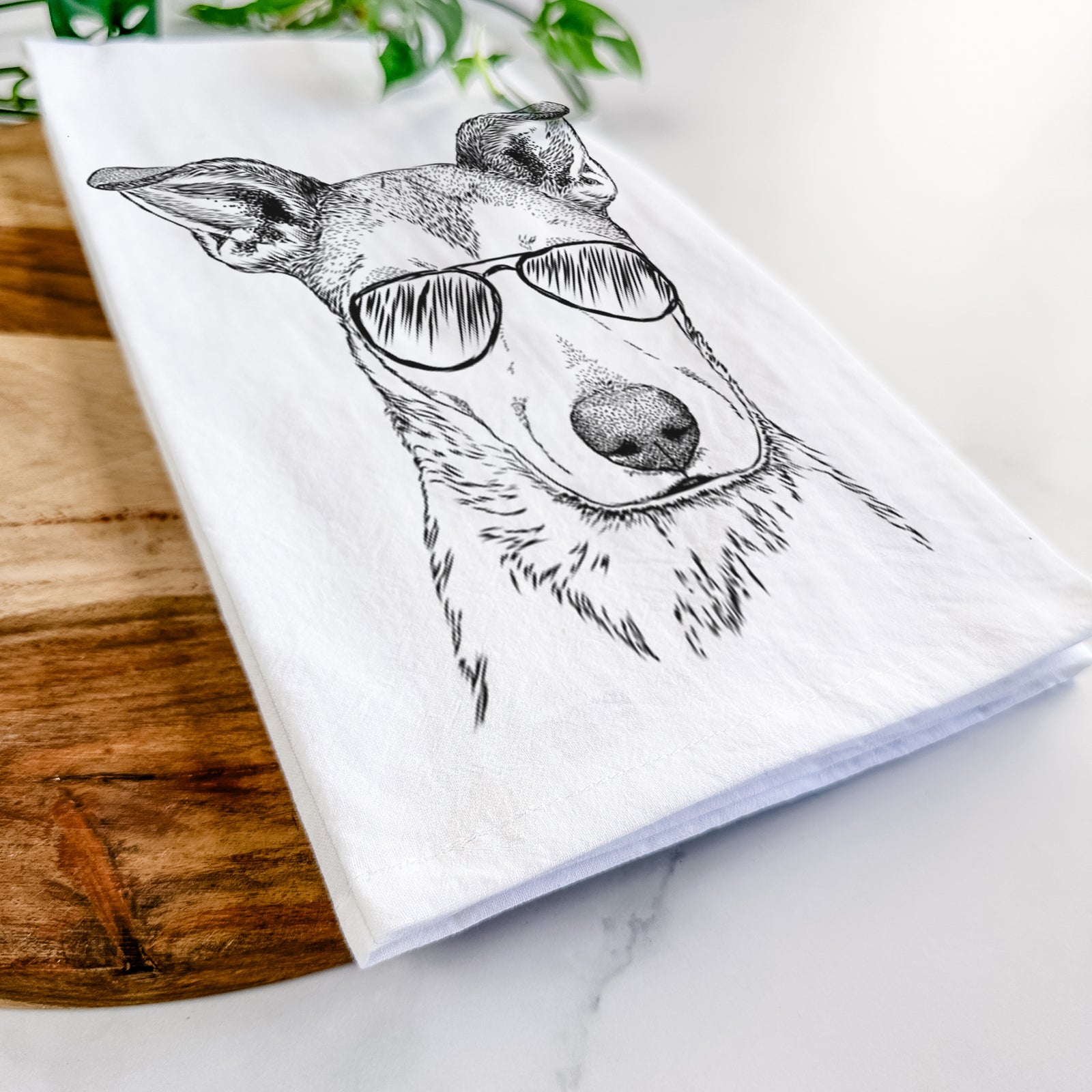 Hand-drawn sketch of Coral the Mixed Breed wearing aviator sunglasses on a tea towel