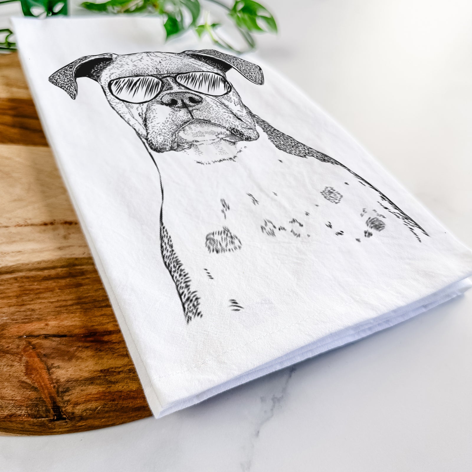 Hand-drawn sketch of Daisy the Boxer wearing aviator sunglasses on a tea towel
