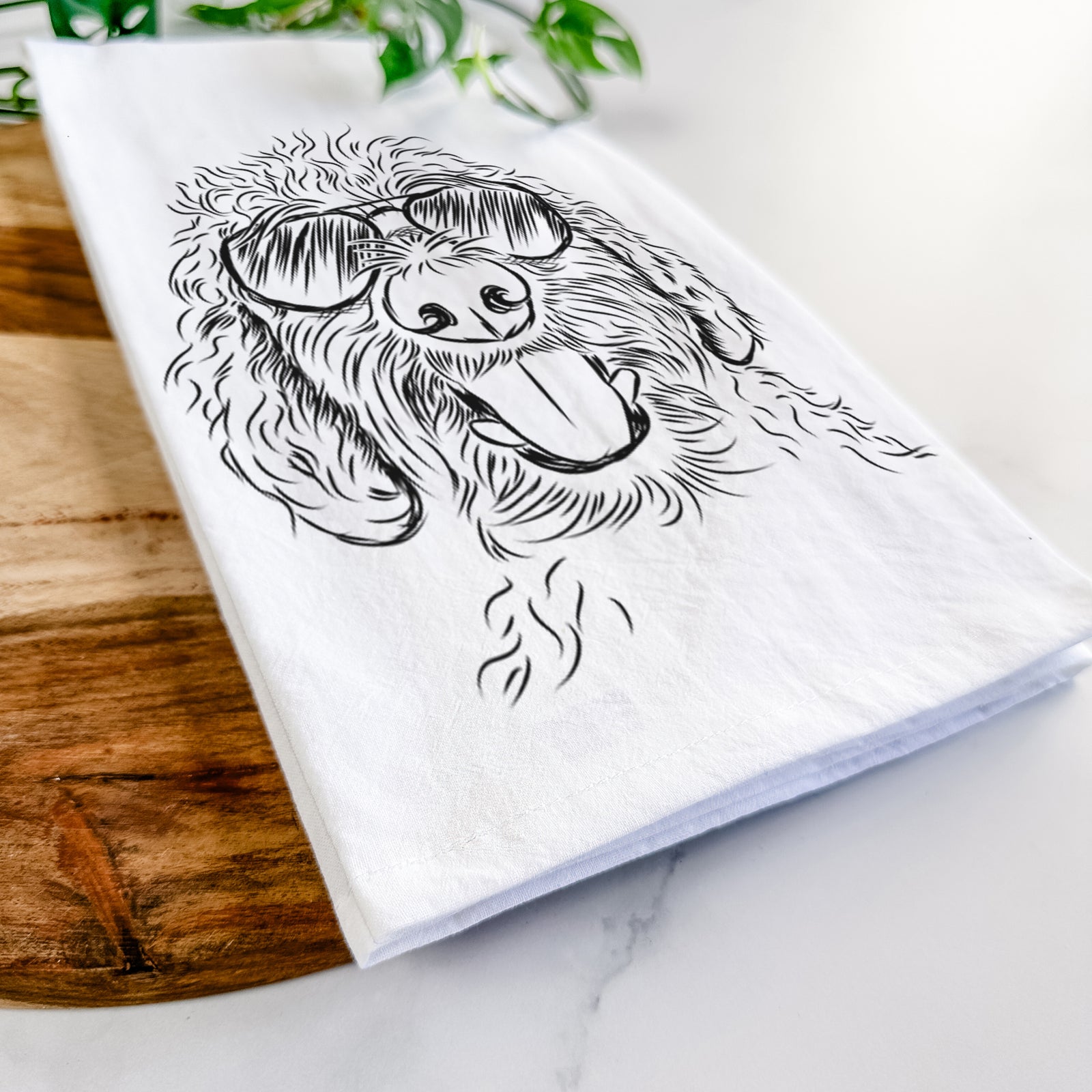 Hand-drawn sketch of Dixie the Doodle wearing aviator sunglasses on a tea towel