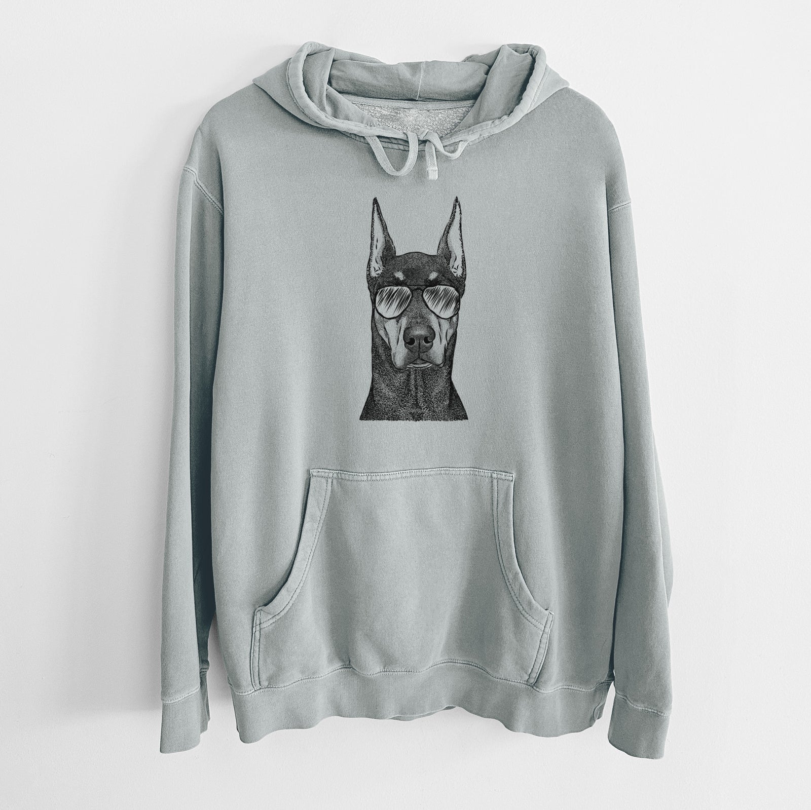 Hand-drawn sketch of Drake the Doberman Pinscher wearing aviator sunglasses on a Sage Unisex pigment dyed hoodie