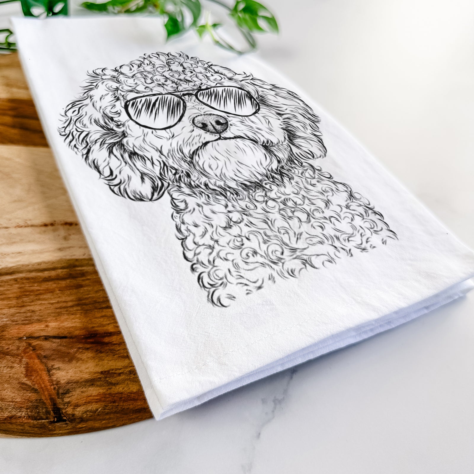 Hand-drawn sketch of Edgar the Shihpoo wearing aviator sunglasses on a tea towel