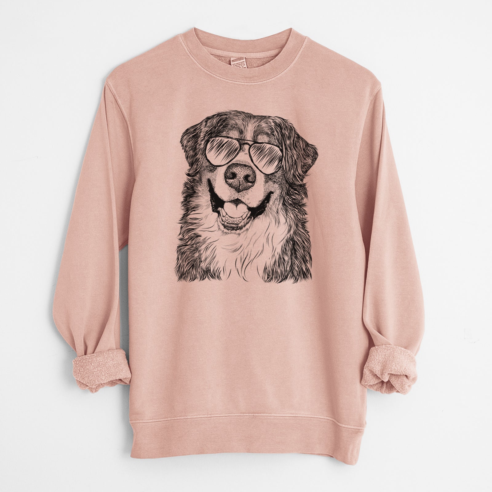 Hand-drawn sketch of Eiger the Bernese Mountain Dog wearing aviator sunglasses on a Dusty Pink Unisex pigment dyed crew sweatshirt