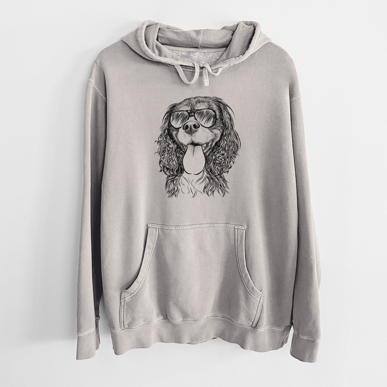 Hand-drawn sketch of Elizabeth the Cavalier King Charles Spaniel wearing aviator sunglasses on a Cement Unisex pigment dyed hoodie