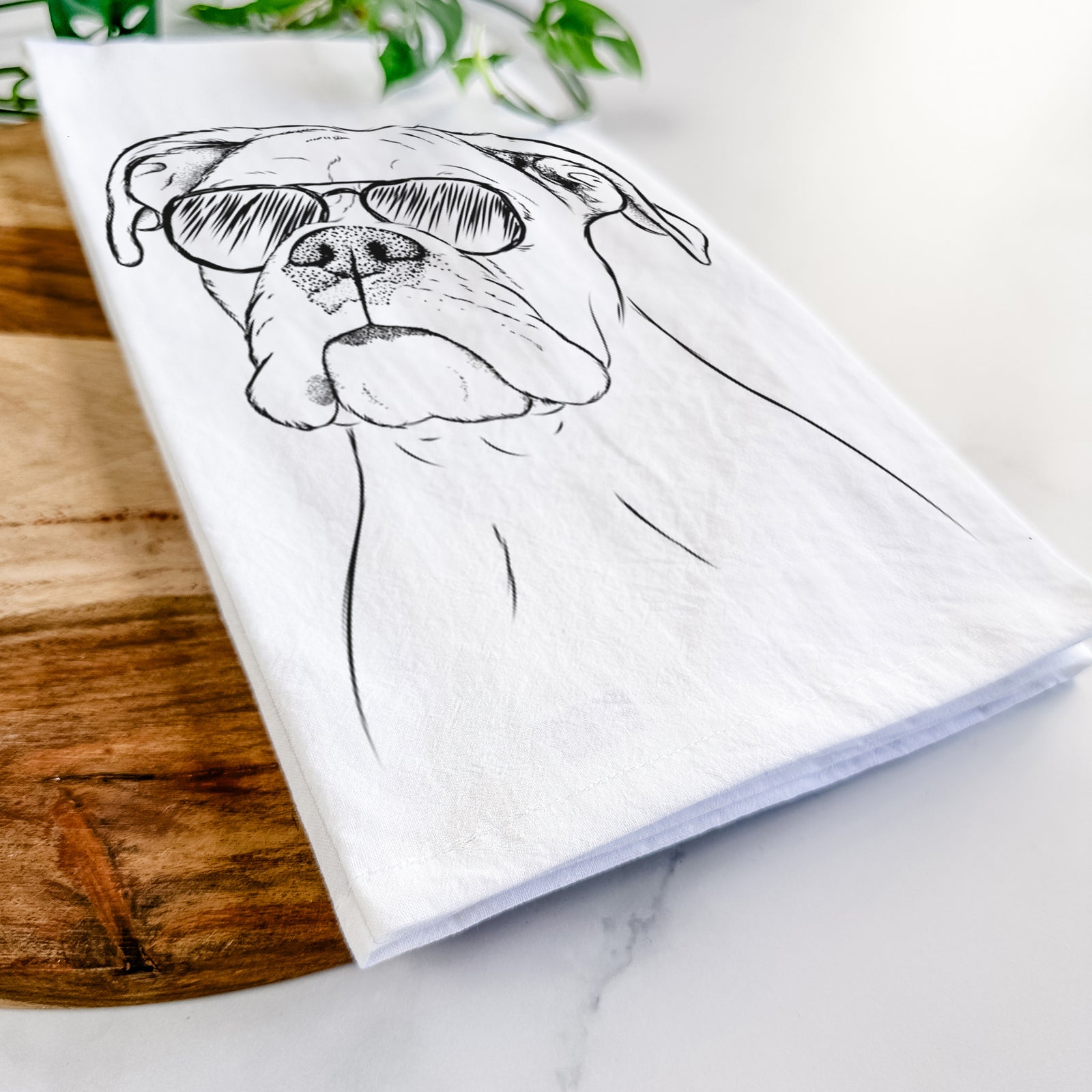 Hand-drawn sketch of Ellie the Boxer wearing aviator sunglasses on a tea towel