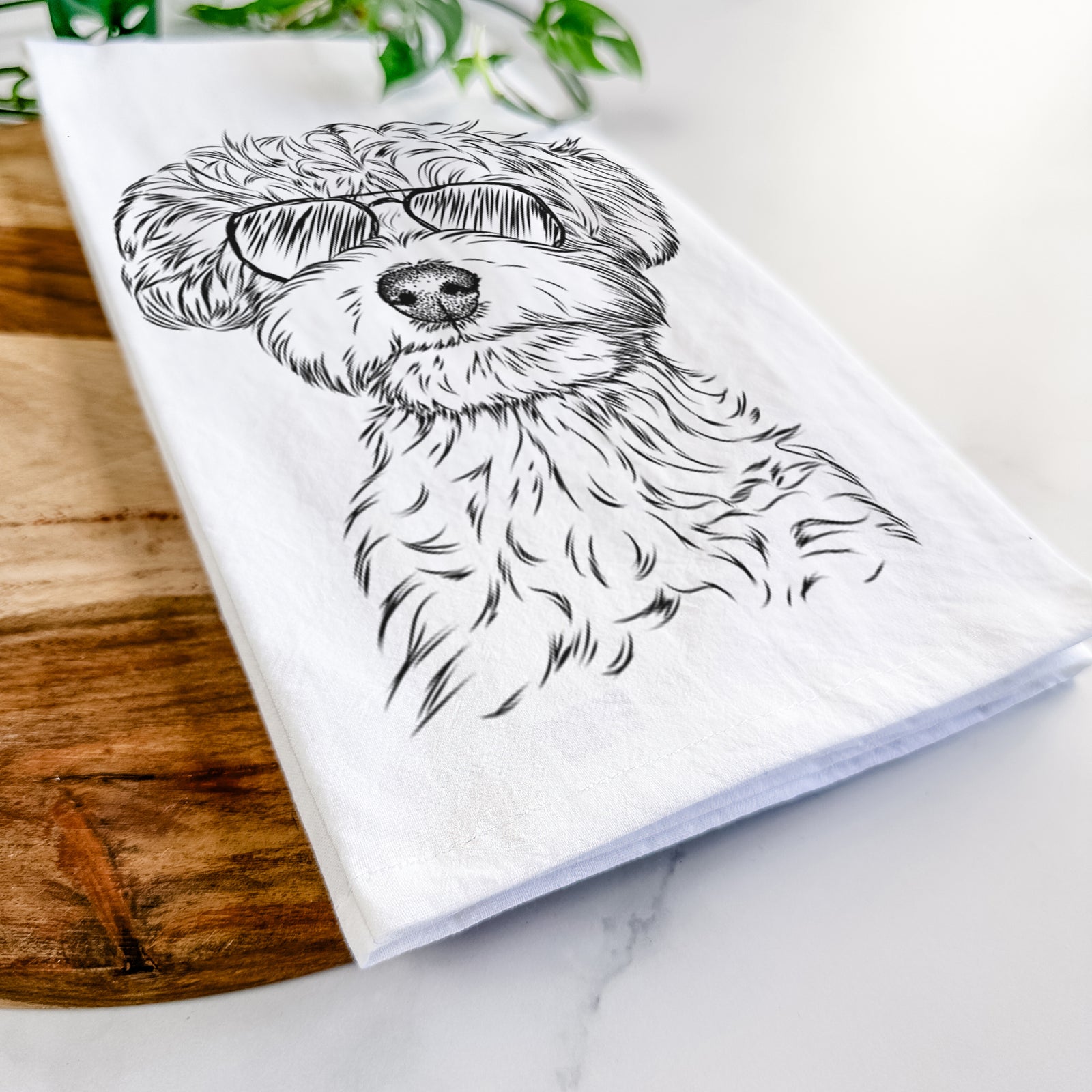 Hand-drawn sketch of Elliott the Yorkiepoo wearing aviator sunglasses on a tea towel