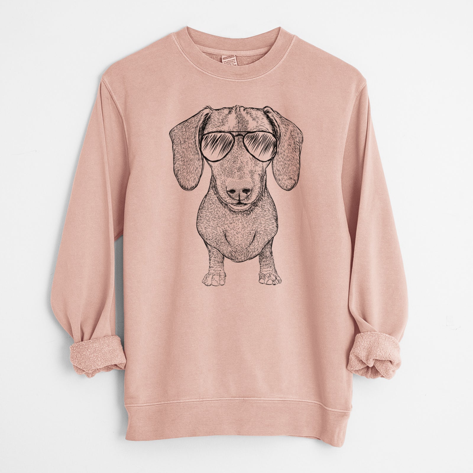 Hand-drawn sketch of Ernie the Mini Dachshund wearing aviator sunglasses on a Dusty Pink Unisex pigment dyed crew sweatshirt