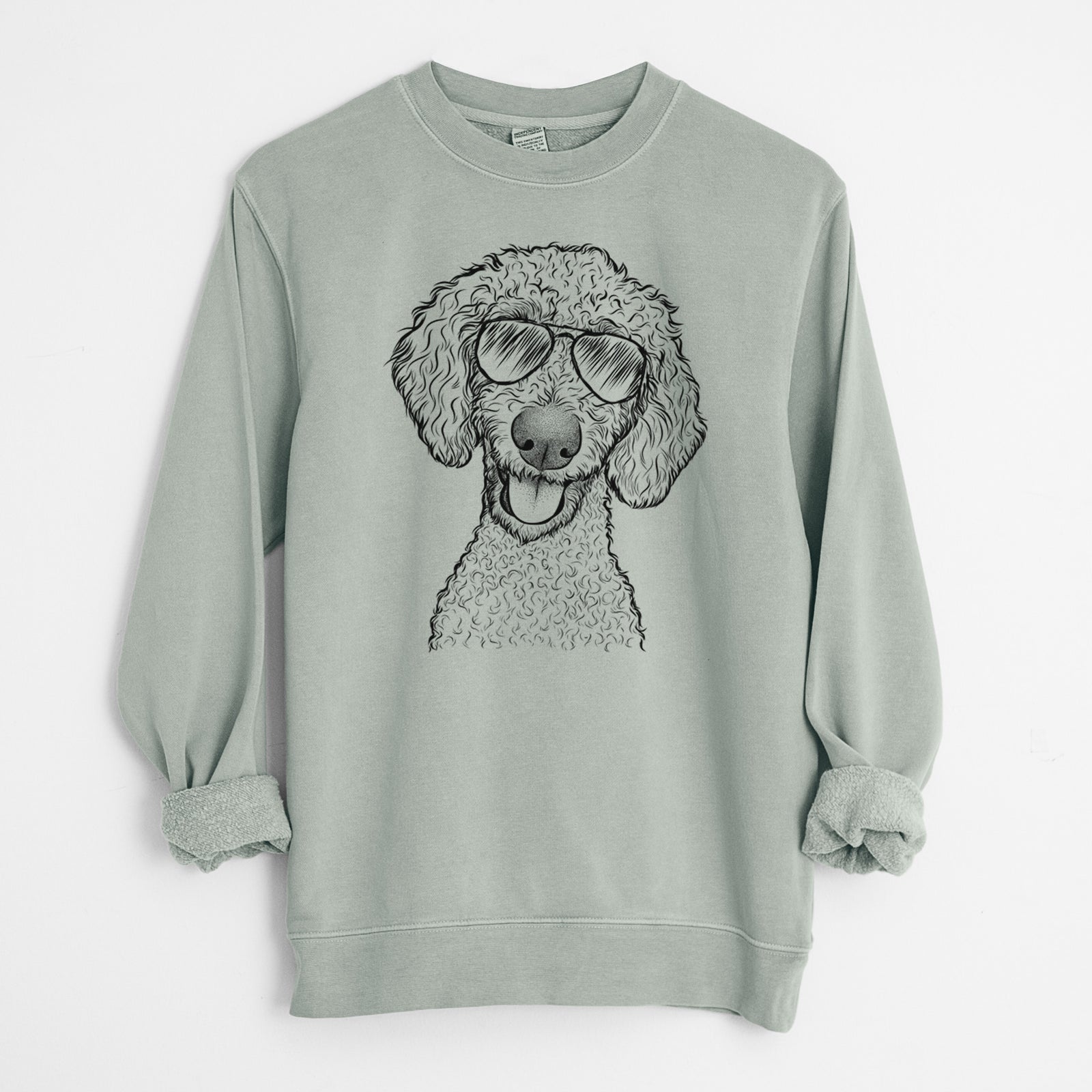 Hand-drawn sketch of Fenway the Goldendoodle wearing aviator sunglasses on a Sage Unisex pigment dyed crew sweatshirt
