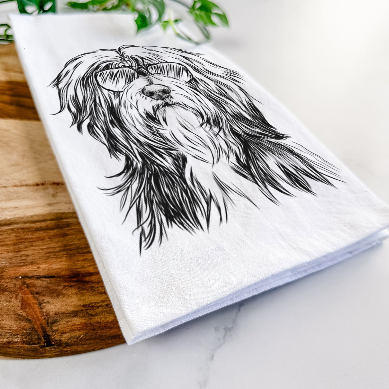 Hand-drawn sketch of Fiji the Polish Lowland Sheepdog wearing aviator sunglasses on a tea towel