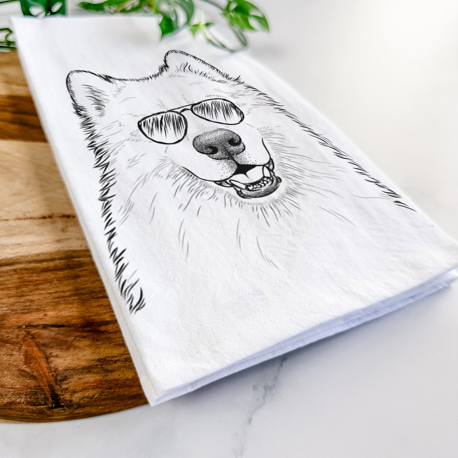 Hand-drawn sketch of Foster the Samoyed wearing aviator sunglasses on a tea towel
