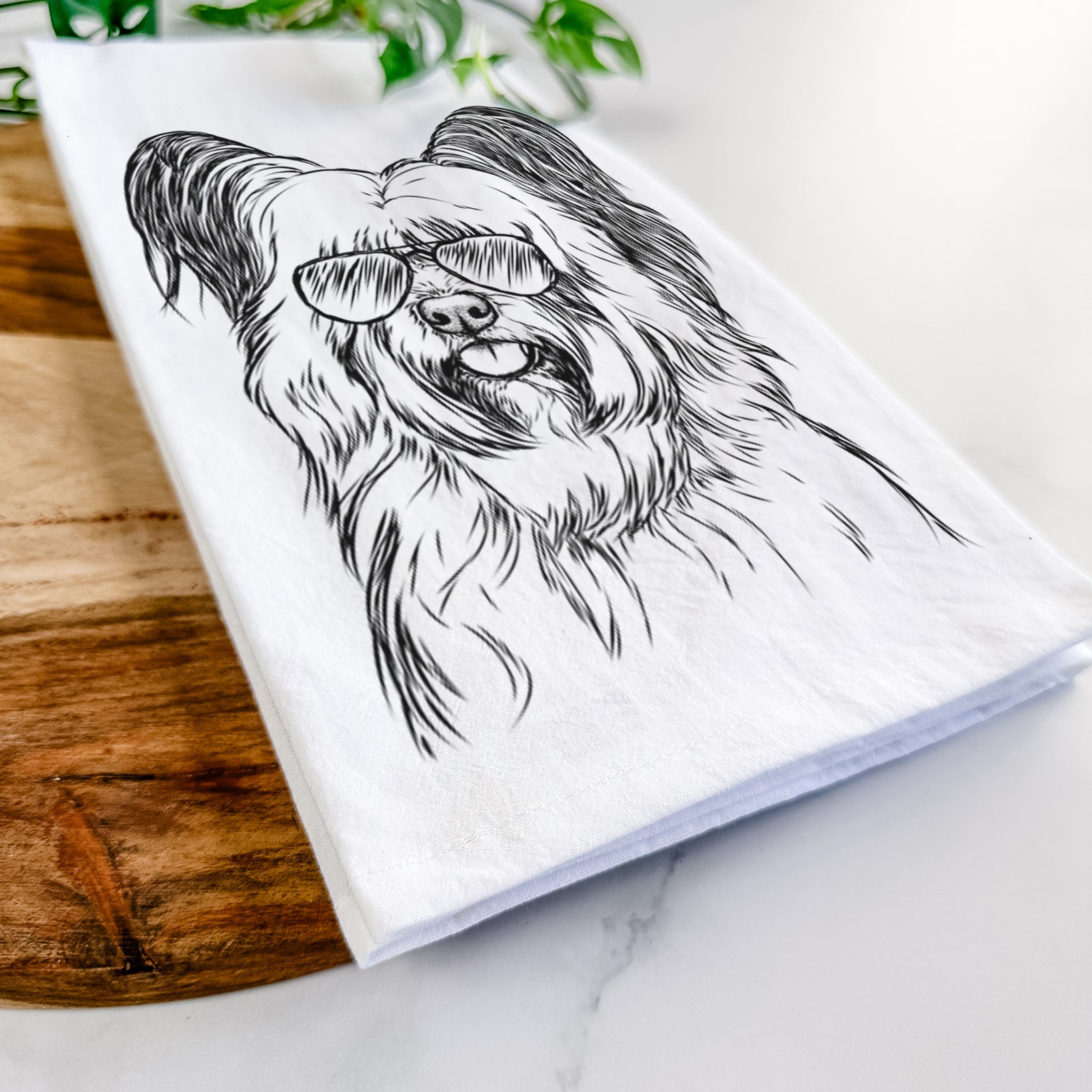 Hand-drawn sketch of Gideon the Skye Terrier wearing aviator sunglasses on a tea towel