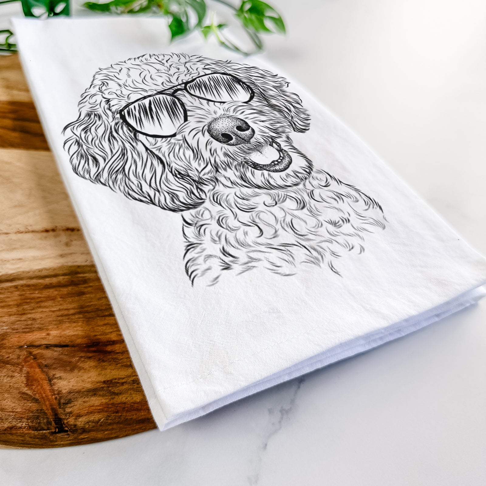 Hand-drawn sketch of Gizmo the Goldendoodle wearing aviator sunglasses on a tea towel