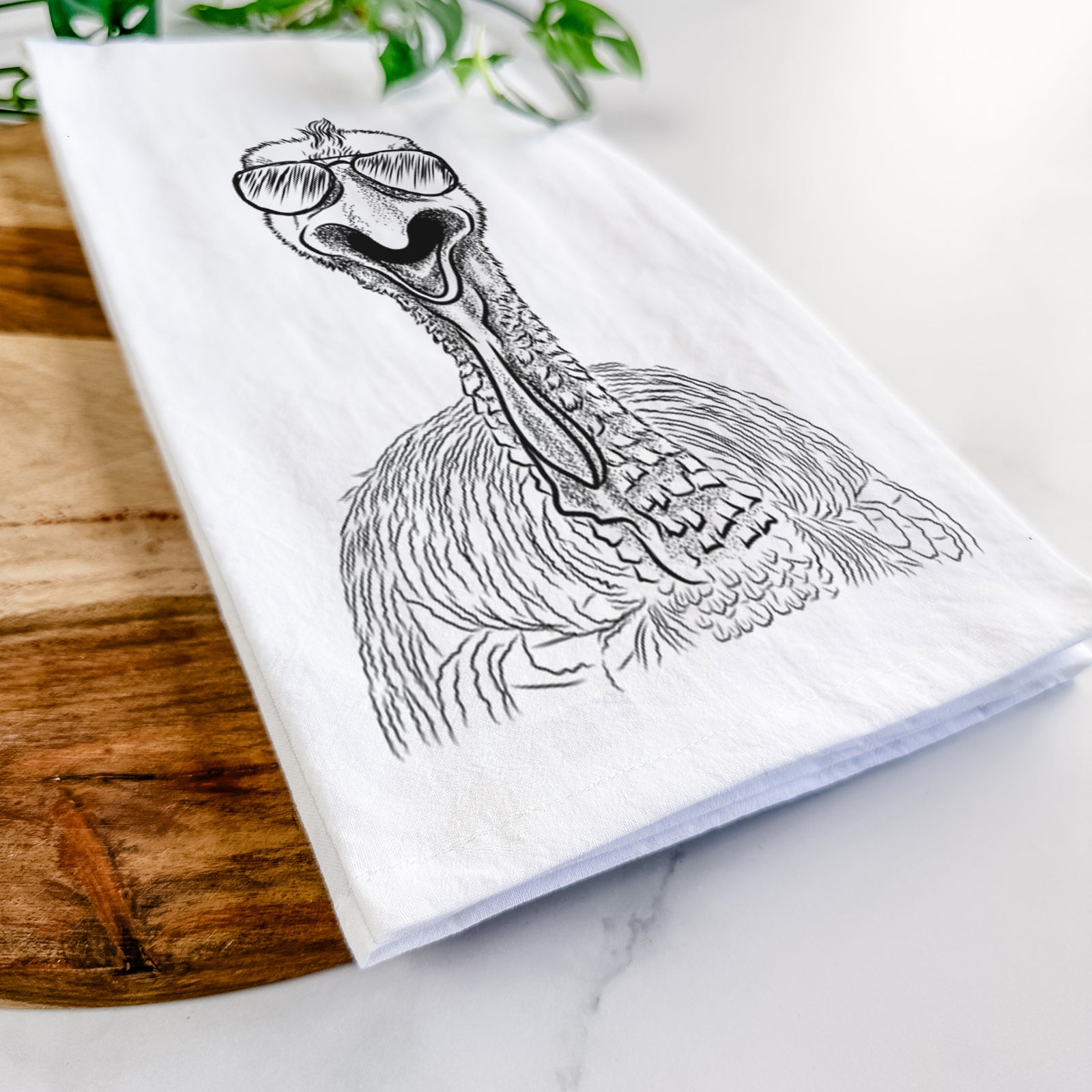 Hand-drawn sketch of Gobble the Turkey wearing aviator sunglasses on a tea towel