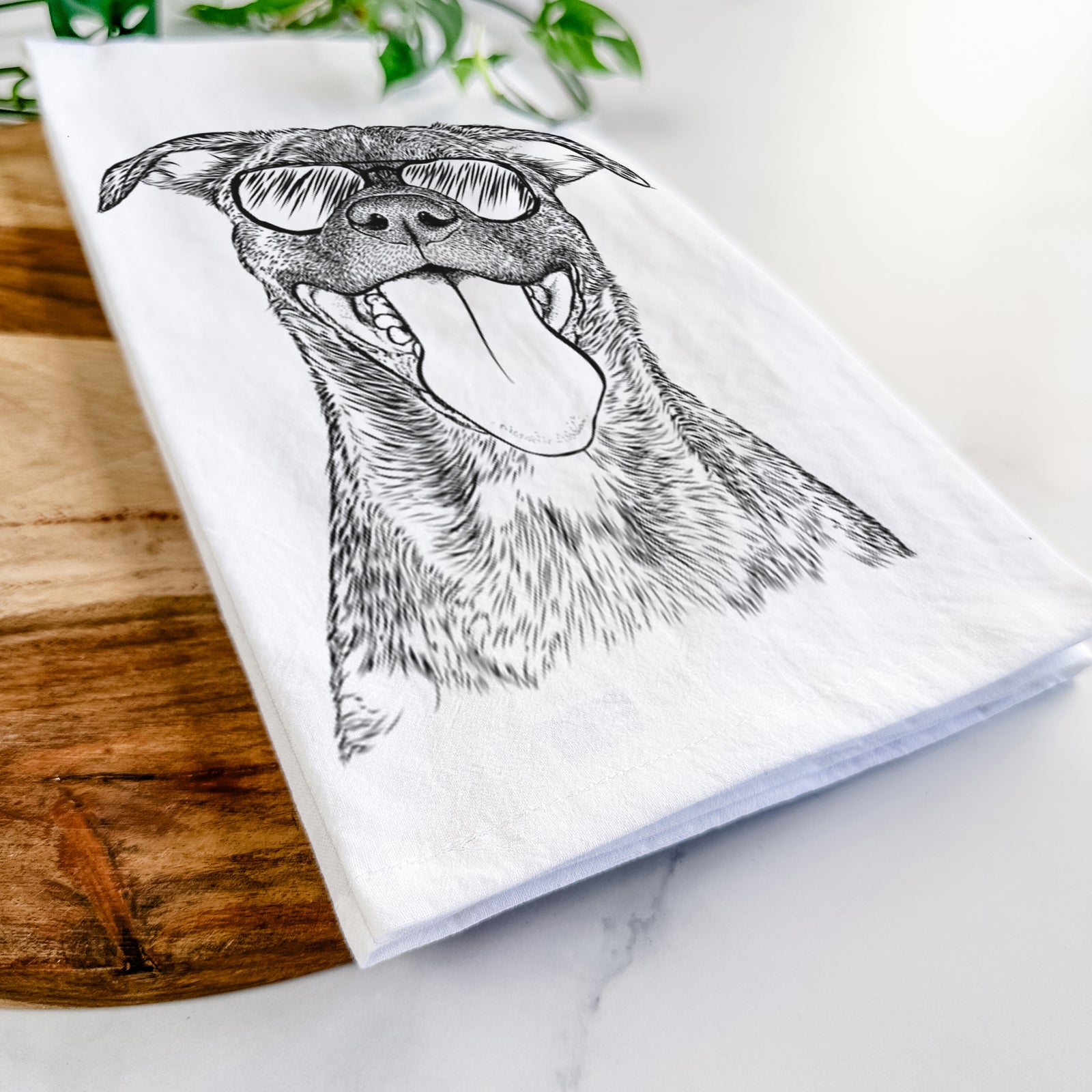 Hand-drawn sketch of Harley the Pitbull Mix wearing aviator sunglasses on a tea towel