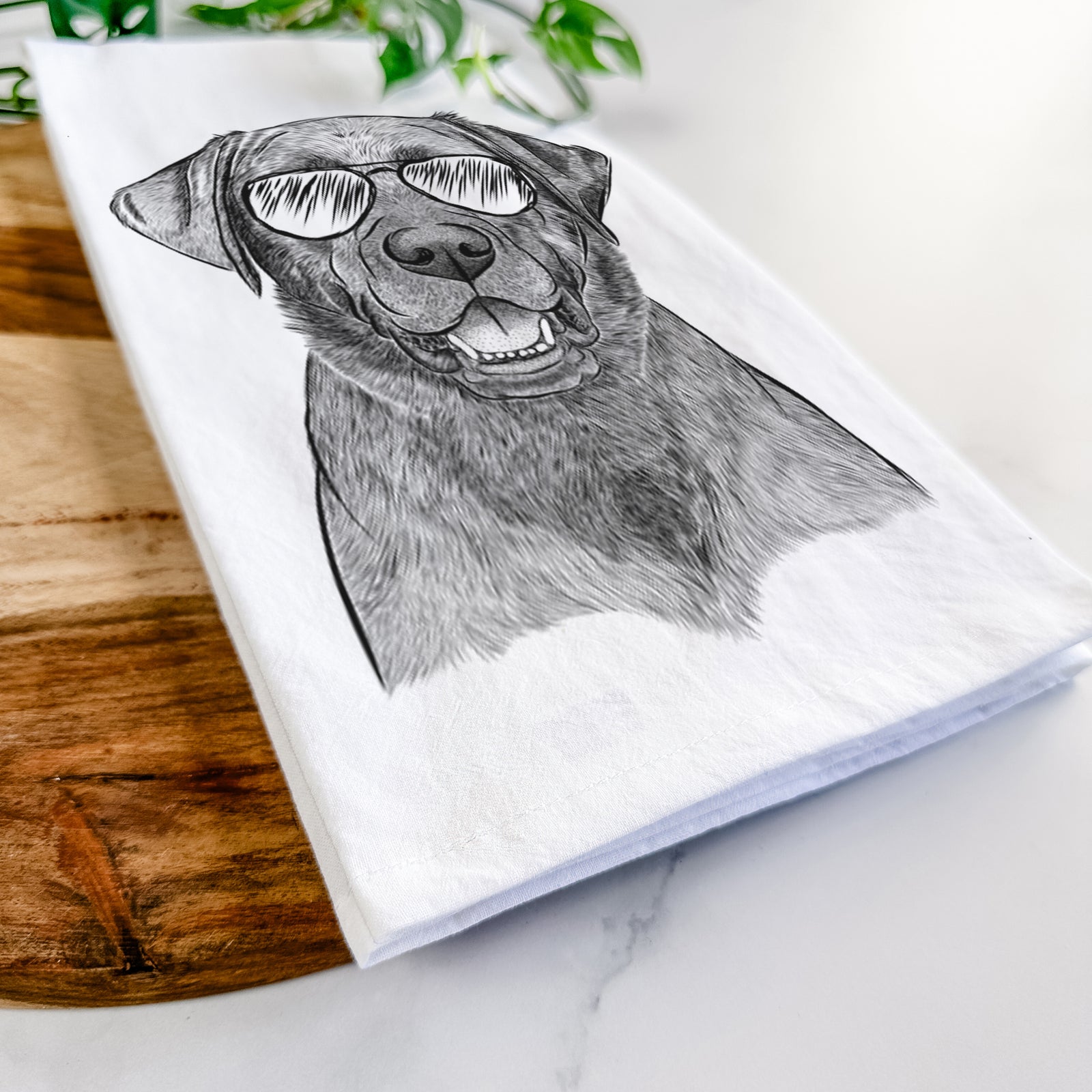 Hand-drawn sketch of Heath the Black Lab wearing aviator sunglasses on a tea towel