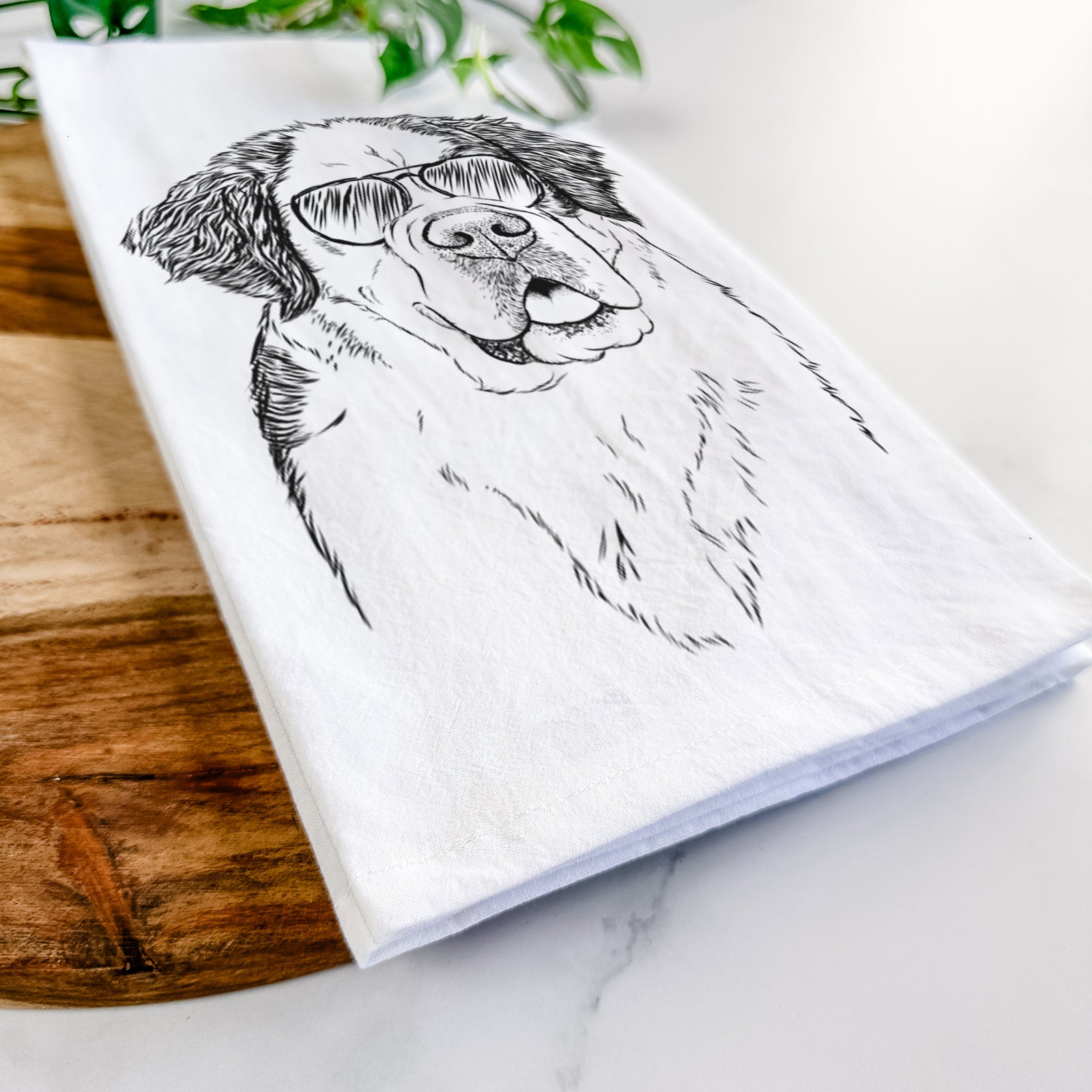 Hand-drawn sketch of Hook the Saint Bernard wearing aviator sunglasses on a tea towel