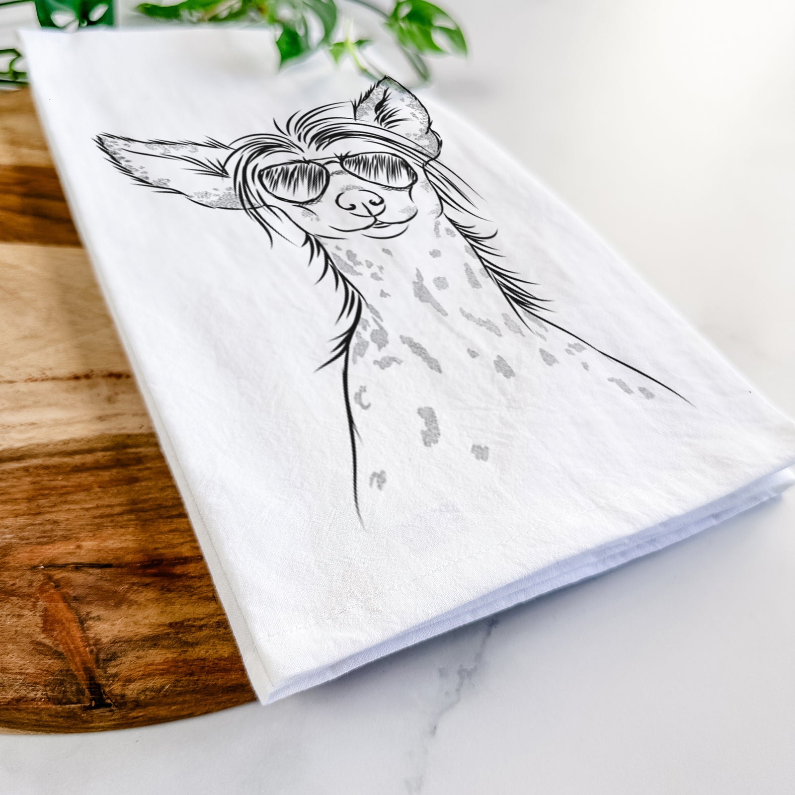 Hand-drawn sketch of Hudson the Chinese Crested wearing aviator sunglasses on a tea towel