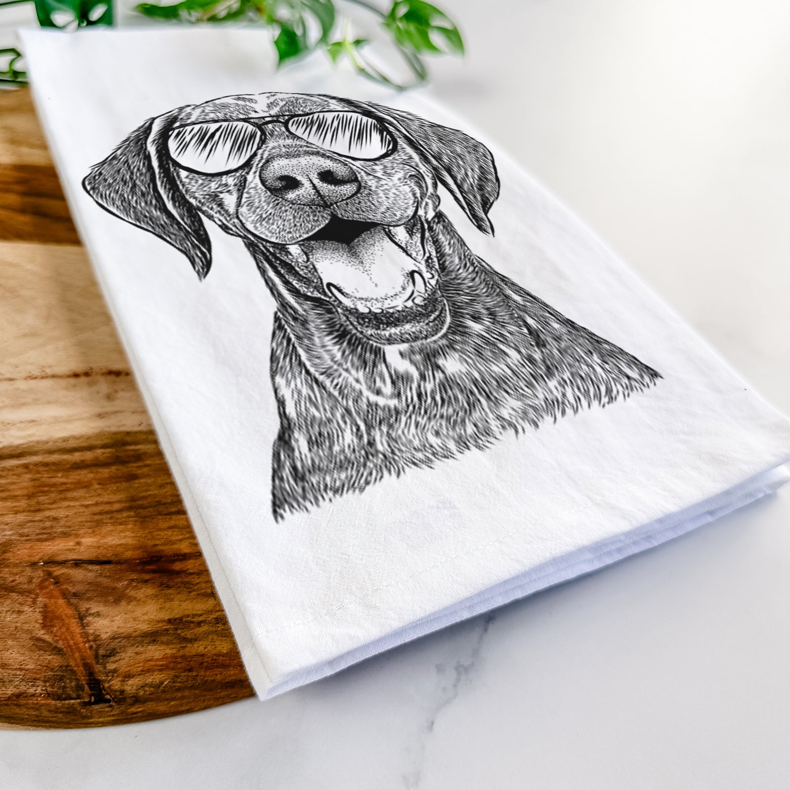 Hand-drawn sketch of Hudson the German Shorthaired Pointer wearing aviator sunglasses on a tea towel