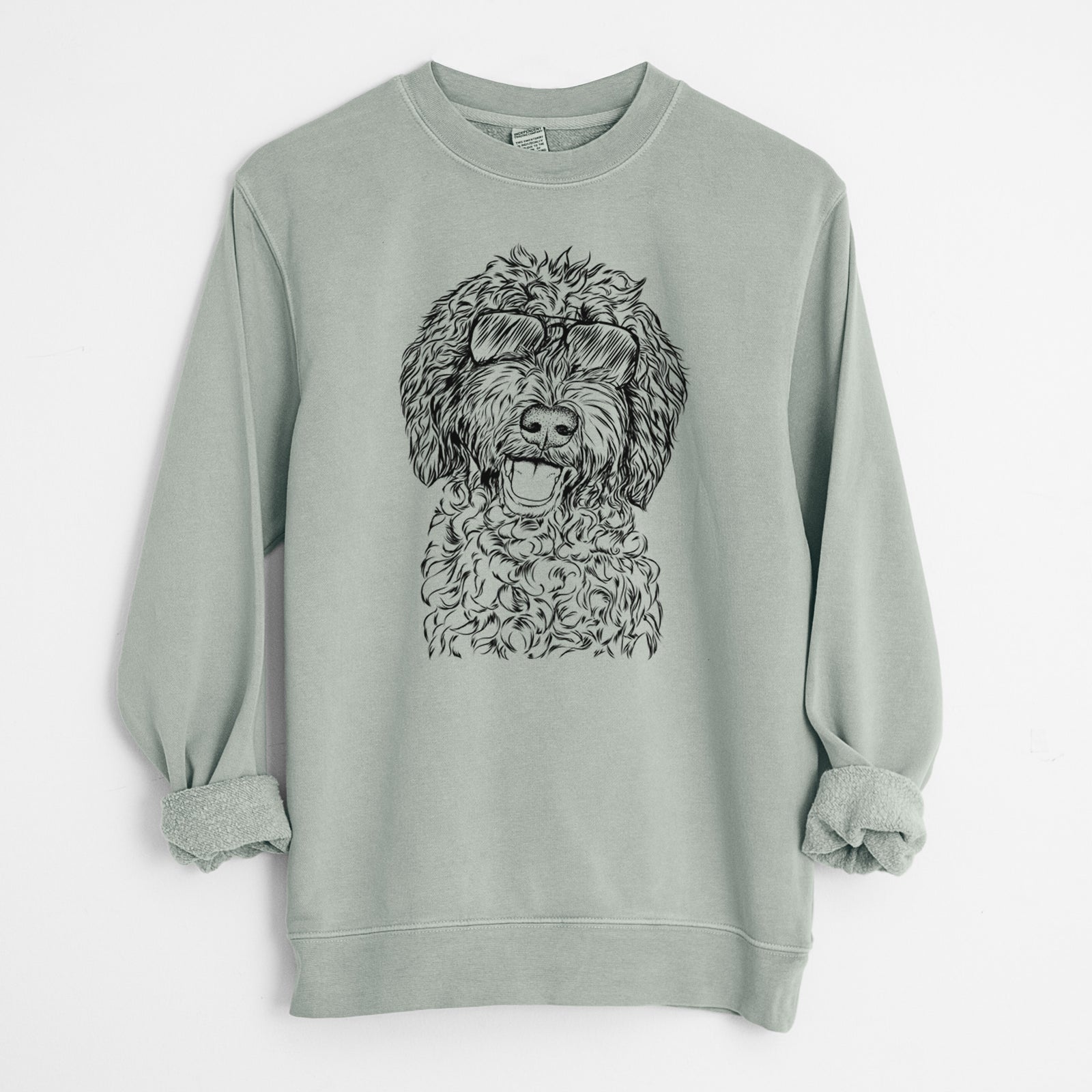 Hand-drawn sketch of Jack the Chocolate Labradoodle wearing aviator sunglasses on a Sage Unisex pigment dyed crew sweatshirt
