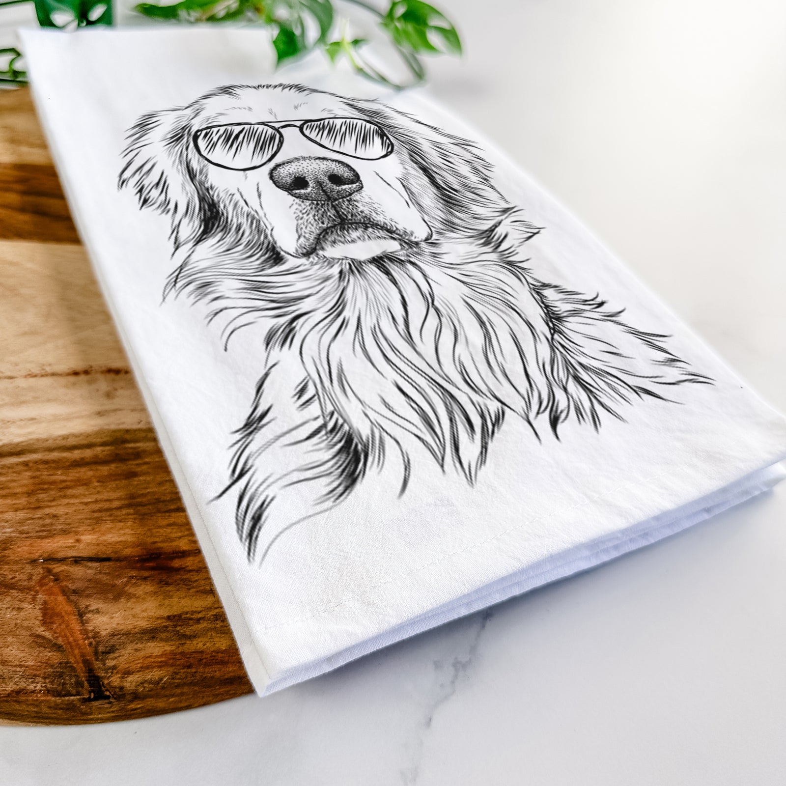 Hand-drawn sketch of Jake aroni the Golden Retriever wearing aviator sunglasses on a tea towel