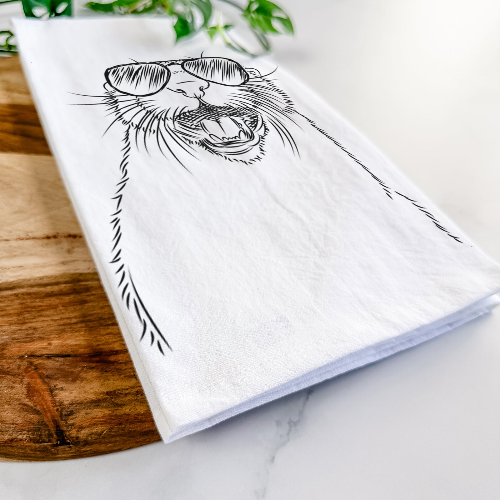 Hand-drawn sketch of Jasper the River Otter wearing aviator sunglasses on a tea towel
