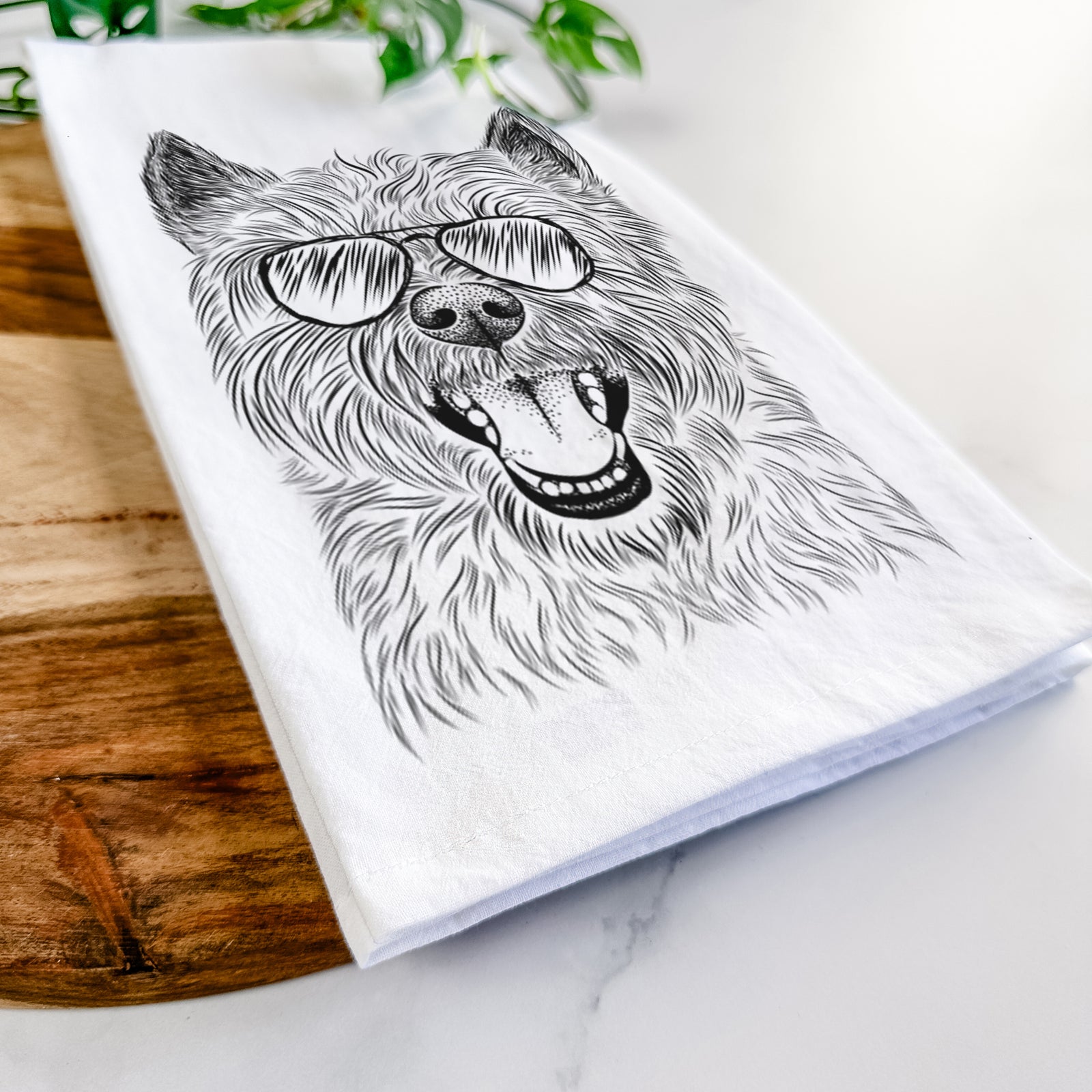 Hand-drawn sketch of Jeff the Cairn Terrier wearing aviator sunglasses on a tea towel