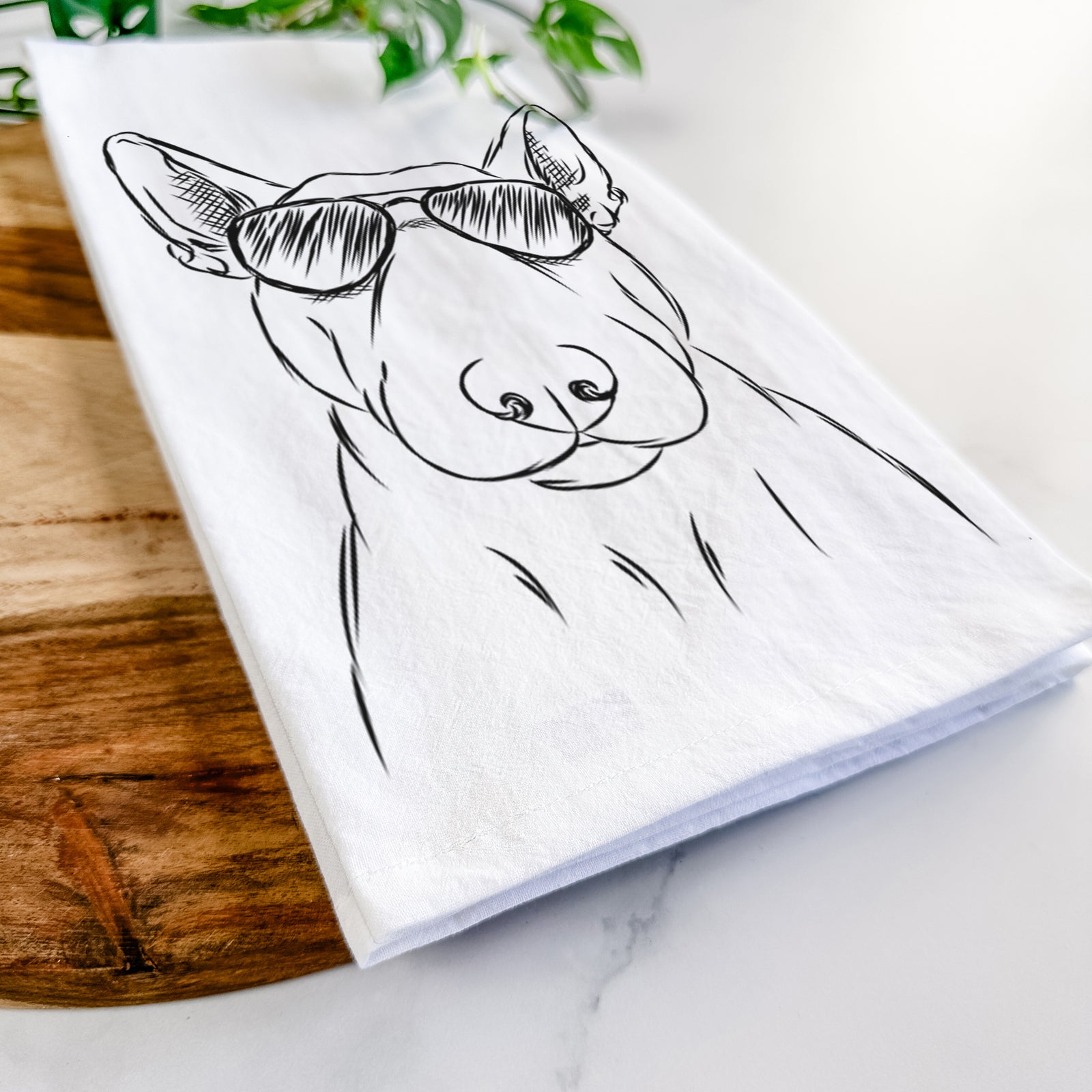Hand-drawn sketch of Jett the Bull Terrier wearing aviator sunglasses on a tea towel