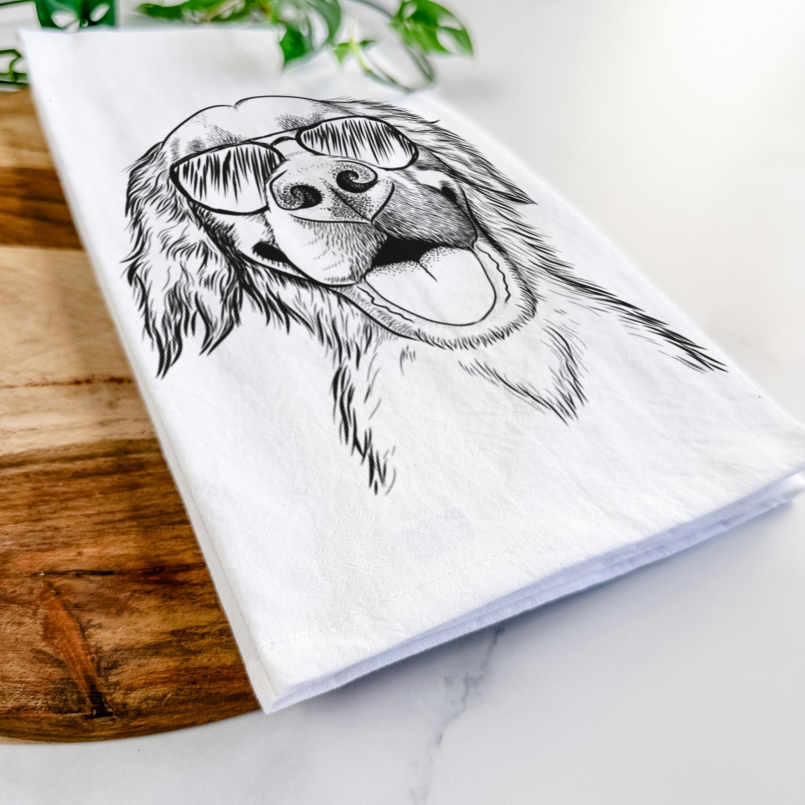 Hand-drawn sketch of Jordy the Golden Retriever wearing aviator sunglasses on a tea towel