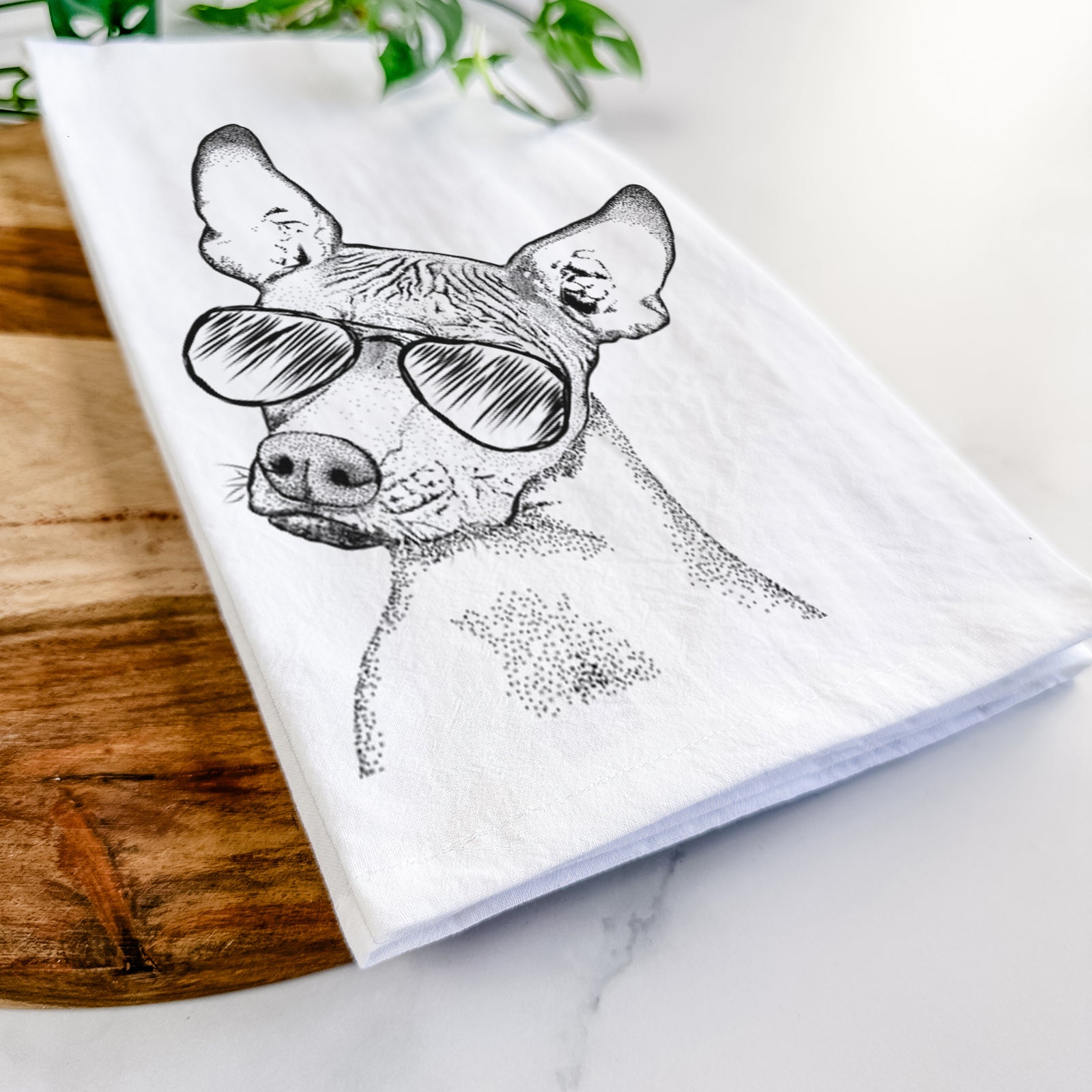 Hand-drawn sketch of Kahlo the Xoloitzcuintli wearing aviator sunglasses on a tea towel