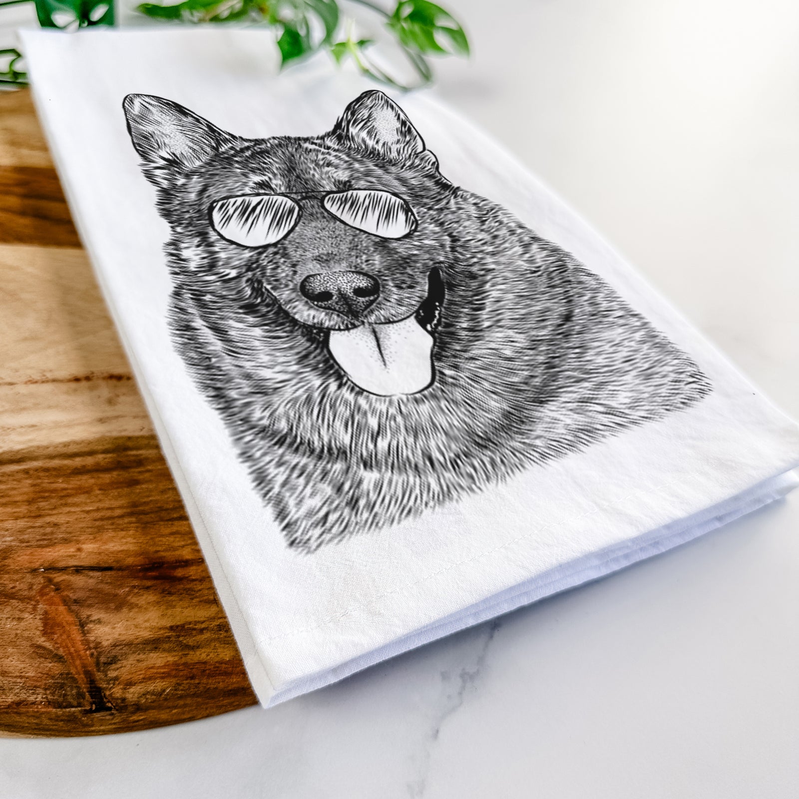 Hand-drawn sketch of Kasia the Norwegian Elkhound wearing aviator sunglasses on a tea towel